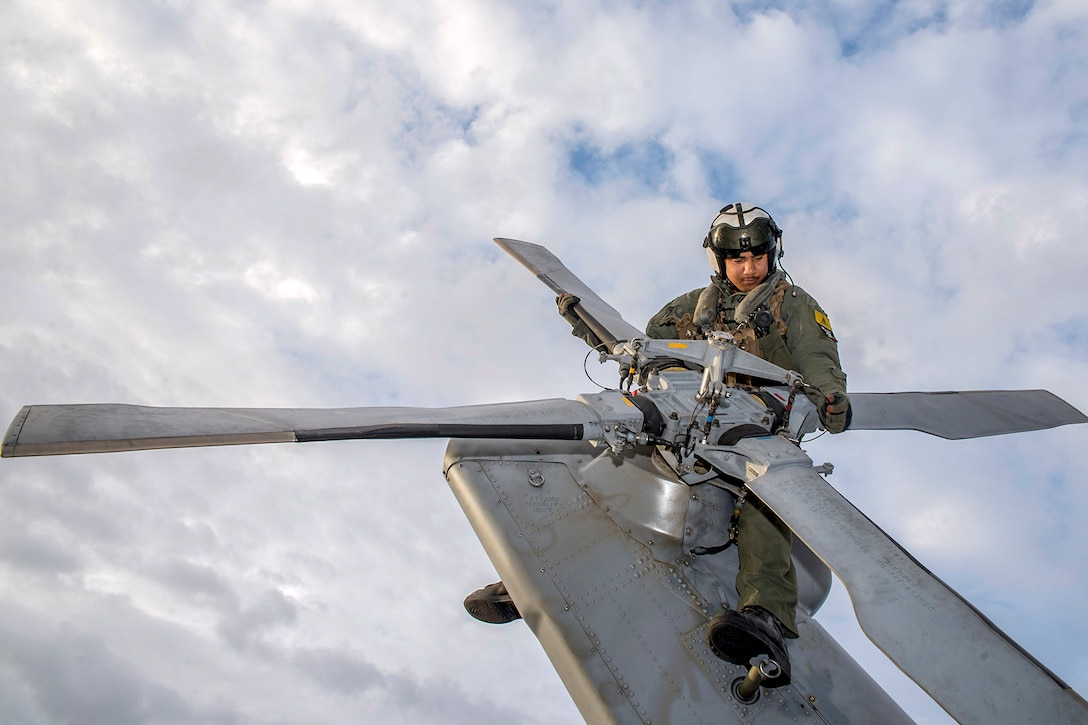Navy Petty Officer 3rd Class Nicholas Farris  inspects the tail rotor of an MH-60S Seahawk helicopter on the flight deck of the amphibious assault ship USS Wasp in the Atlantic Ocean, April 14, 2016. Navy photo by Seaman Michael Molina