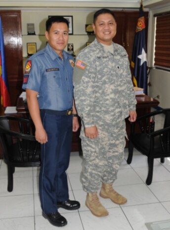 MANILA, Philippines – Officer Christian Celestino (left), a police officer with the Philippine National Police, and Spc. Roel Fantilanan, a U.S. Army Soldier in the 25th Infantry Division, and native of Koronadal City, Philippines, stand shoulder-to-shoulder, April 7, during a visit to Philippine National Police Camp, in Manila, Philippines. Fantilanan met with several classmate from his pervious unit and shared his experience in the U.S. Army. 