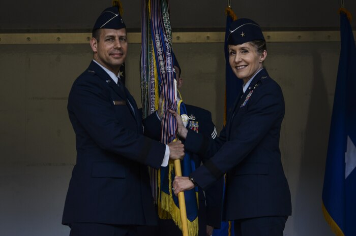 Brig. Gen. Jeannie M. Leavitt (right) assumes command of the 57th Wing from Brig. Gen. Paul A. Welch, U.S. Air Force Warfare Center vice commander, during a change of command ceremony at the Strike Aircraft Maintenance Unit hangar at Nellis Air Force Base, Nev., April 15. Leavitt is responsible for 34 squadrons at 13 installations constituting the Air Force's most diverse flying wing. (U.S. Air Force photo by Airman 1st Class Kevin Tanenbaum)