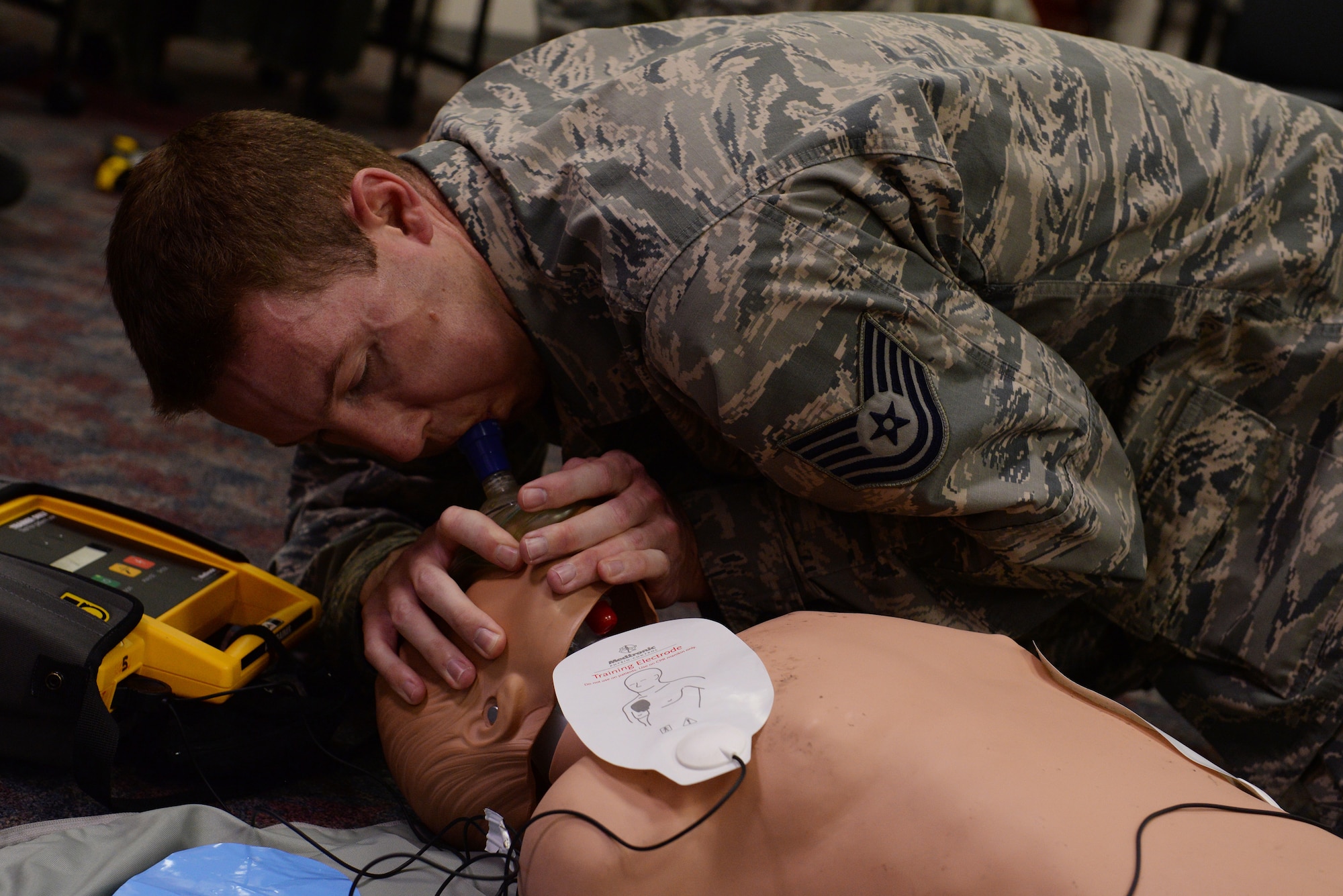 Tech. Sgt. Jeremy Cole, 375th Operations Support Squadron Airfield Systems technician, practices giving CPR during a basic life support class at the 375th Medical Group clinic April 6, 2016. When conducting CPR, the person can use a face mask, which protects them from accidental exposure to infection and disease, even though the risk is low, according to Clyde Nobles, Public Access Defibrillator program coordinator and instructor. (U.S. Air Force photo by Staff Sgt. Maria Bowman)