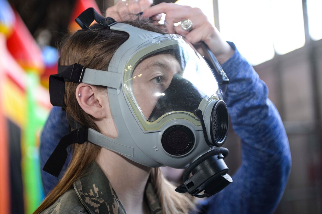 Caitlyn Parks, daughter of Master Sgt. Timothy Parks, 28th Civil Engineer Squadron heating, ventilation, air condition and refrigeration NCO in charge, dons a gas mask during the kids’ deployment line at Ellsworth Air Force Base, S.D., April 9, 2016. The event was hosted to commemorate military children and the sacrifices made while their parent(s) serve. (U.S. Air Force photo by Airman 1st Class Sadie Colbert/Released)