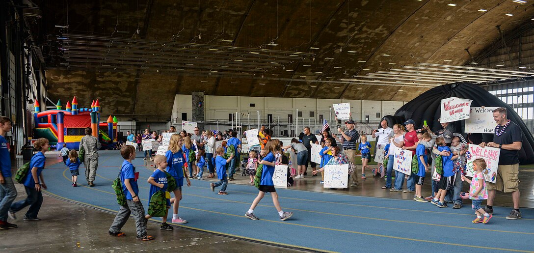 Military children are welcomed home by their parents while returning from a simulated deployment at Ellsworth Air Force Base, S.D., April 9, 2016. The simulated deployment was held to help children connect with their parents by showing them what their mom or dad go through whendeployed. (U.S. Air Force photo by Airman 1st Class Sadie Colbert/Released)
