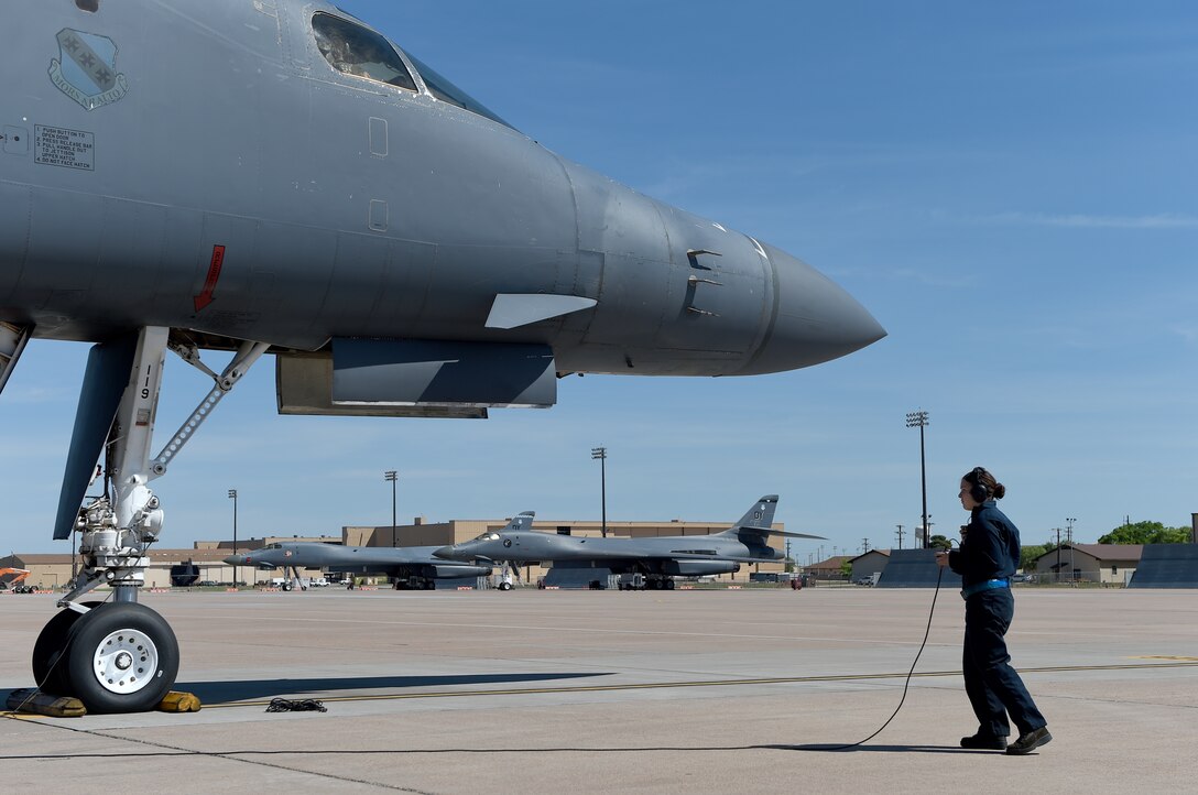 U.S. Air Force Airman 1st Class Gabriella Vanlaarhoven, 28th Aircraft Maintenance Unit, communicates with pilots in a B-1B Lancer prior to taxiing April 5, 2016, at Dyess Air Force Base, Texas. As a crew chief, part of Vanlaarhoven’s job is to conduct pre-flight maintenance checks on the aircraft. (U.S. Air Force photo by Senior Airman Alexander Guerrero/Released)