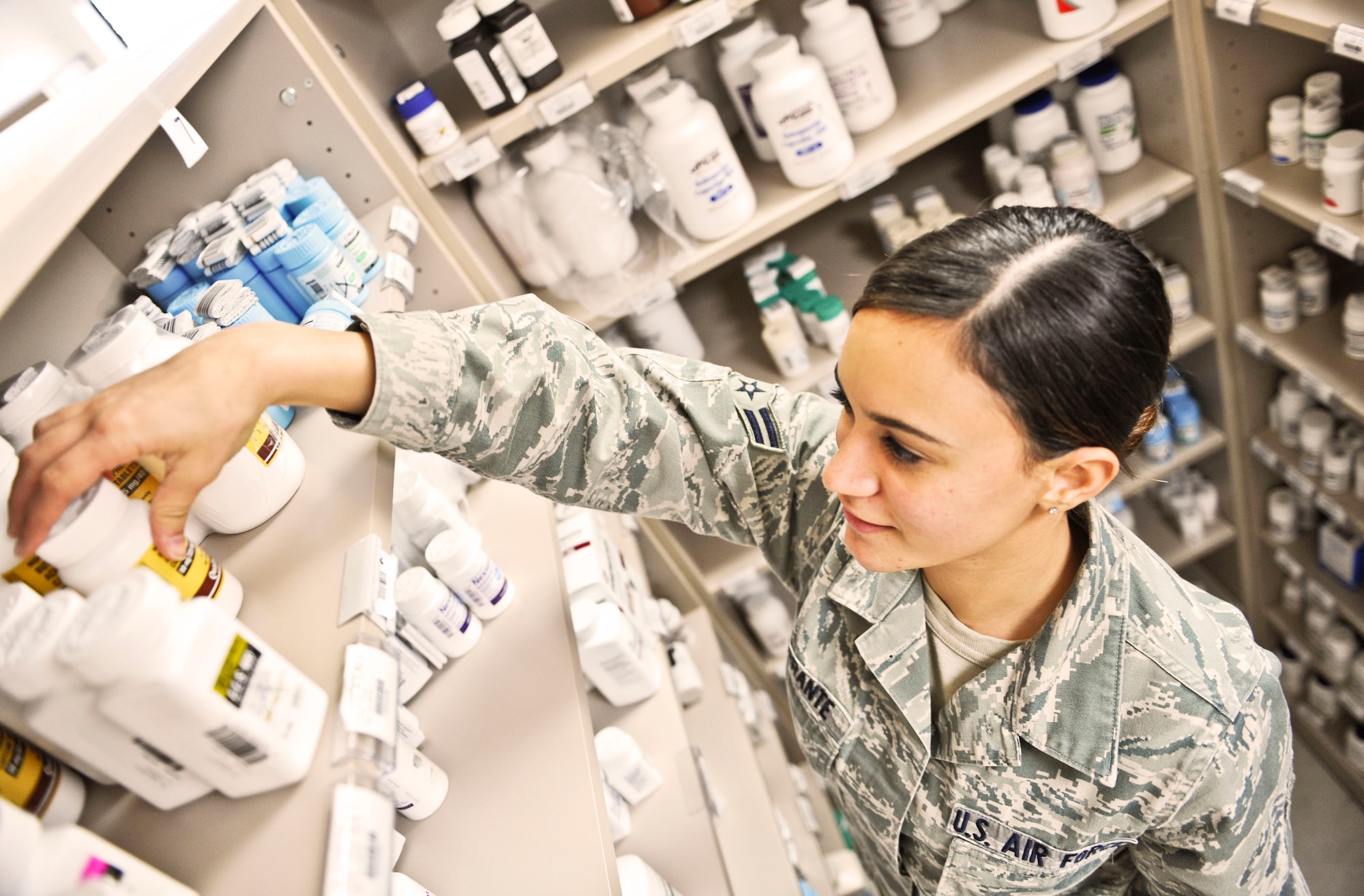 U.S. Air Force Airman 1st Class Julianna Ferrante, 7th Medical Support Squadron pharmacy technician, reaches for a prescription at the Dyess pharmacy, Oct. 22, 2013, at Dyess Air Force Base, Texas. The Self Initiated Care Kit is a new program offered by the MDG that allows Airmen, their dependents and retirees already receiving pharmaceutical benefits under Tricare to access free over-the-counter medication without requiring an appointment at the clinic. To access the over-the-counter medication, individuals fill out a form located in the pharmacy or online (http://www.dyess.af.mil/library/factsheets/factsheet.asp?id=22835), and select the medication they need. (U.S. Air Force photo by Airman 1st Class Kedesha Pennant/Released)