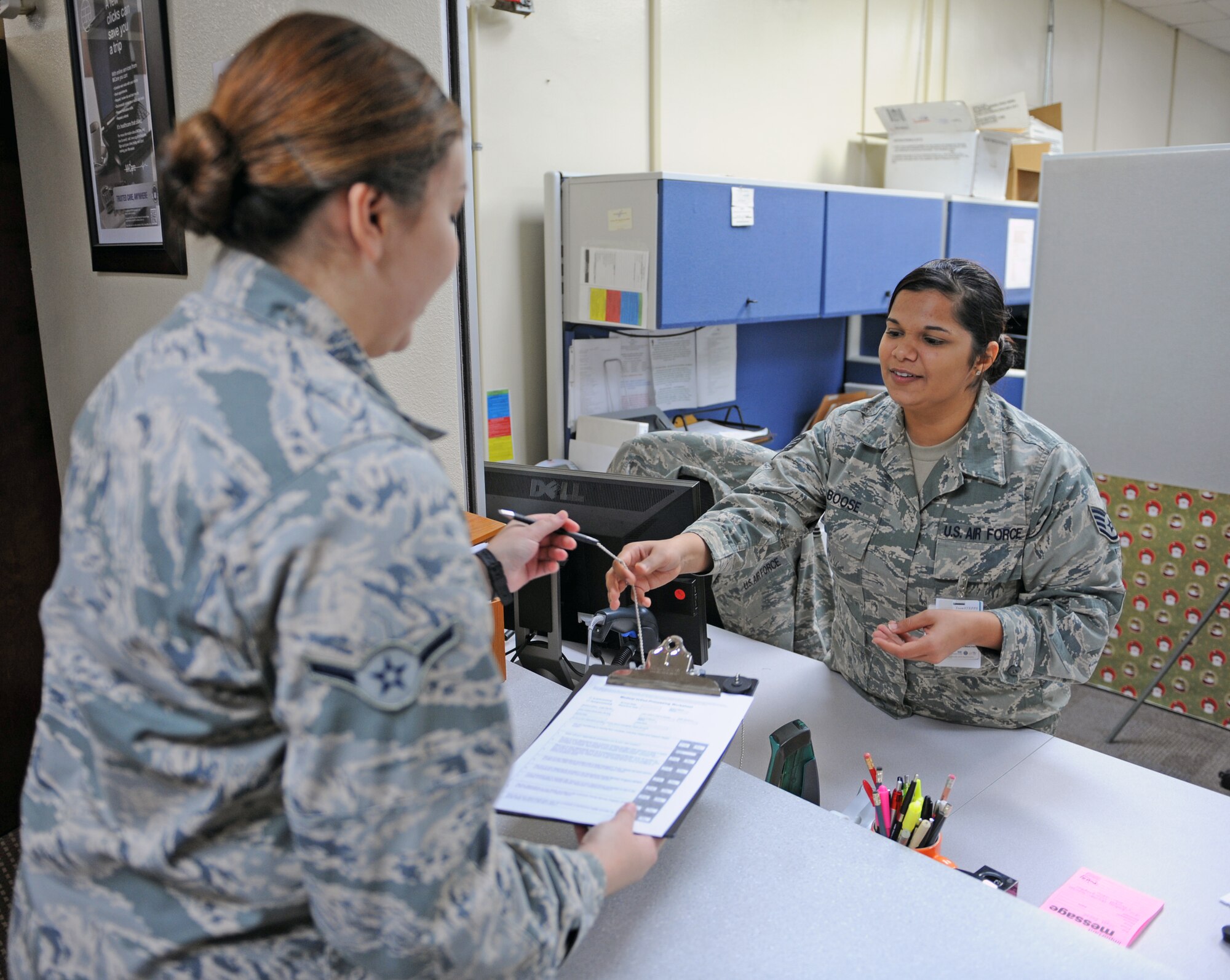 U.S. Air Force Staff Sgt. Soni Boose, 7th Medical Group, helps an Airman fill out paperwork Dec. 19, 2013, at Dyess Air Force Base, Texas. The Self Initiated Care Kit is a new program offered by the MDG that allows Airmen, their dependents and retirees already receiving pharmaceutical benefits under Tricare to access free over-the-counter medication without requiring an appointment at the clinic. To access the over-the-counter medication, individuals fill out a form located in the pharmacy or online (http://www.dyess.af.mil/library/factsheets/factsheet.asp?id=22835), and select the medication they need. (U.S. Air Force photo by Airman 1st Class Kedesha Pennant/Released)