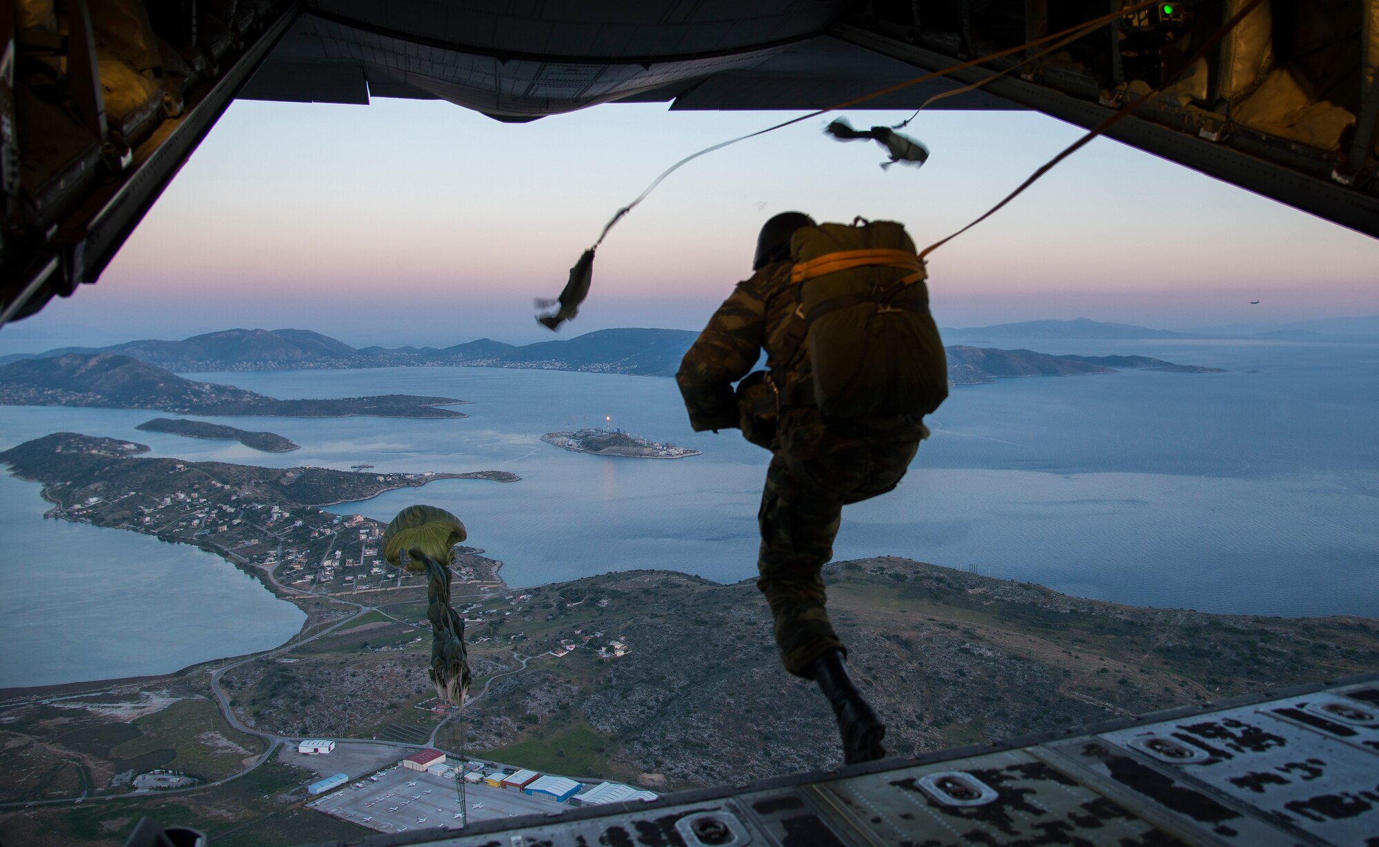 A Greek paratrooper exits a U.S. Air Force C-130J Super Hercules during Stolen Cerberus III above Elefsis, Greece, April 12, 2016. The flying-training deployment provided different training scenarios, which enabled the allied services to work together and gain a better understanding of how each other operates. (U.S. Air Force photo/Staff Sgt. Nancy Kasberg)