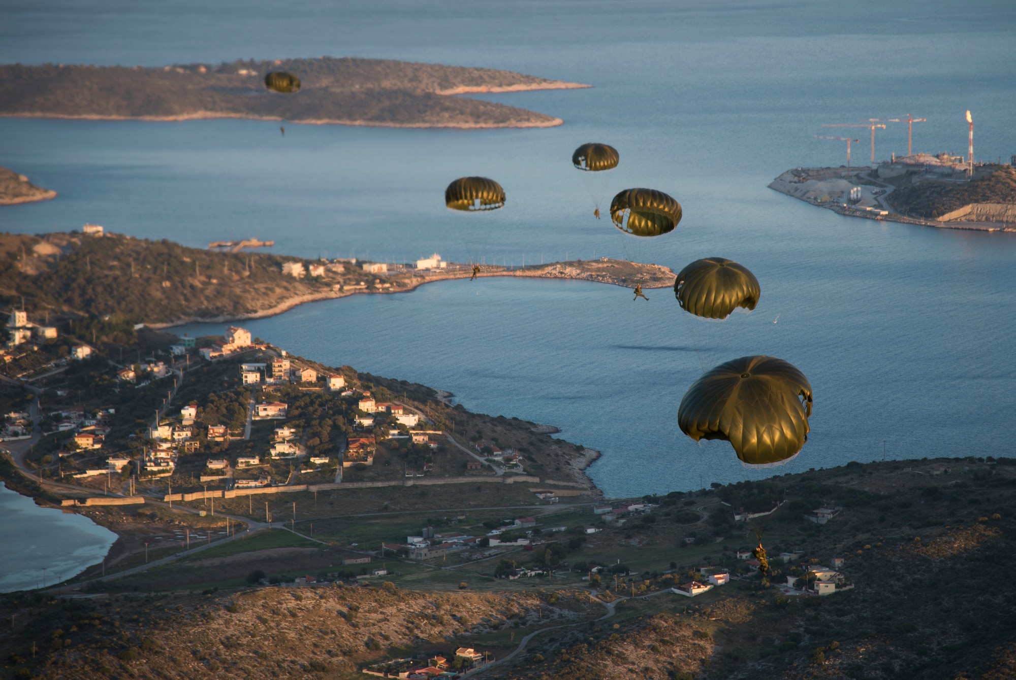 Greek paratroopers descend to the drop zone after exiting a U.S. Air Force C-130J Super Hercules during Stolen Cerberus III above Elefsis, Greece, April 12, 2016. Greek land and special operations forces were able to jump from U.S. aircraft, under the supervision of a joint team of U.S. jumpmasters.  This is the third year in a row that the U.S. and Greeks have conducted exercise Stolen Cerberus. (U.S. Air Force photo/Staff Sgt. Nancy Kasberg)