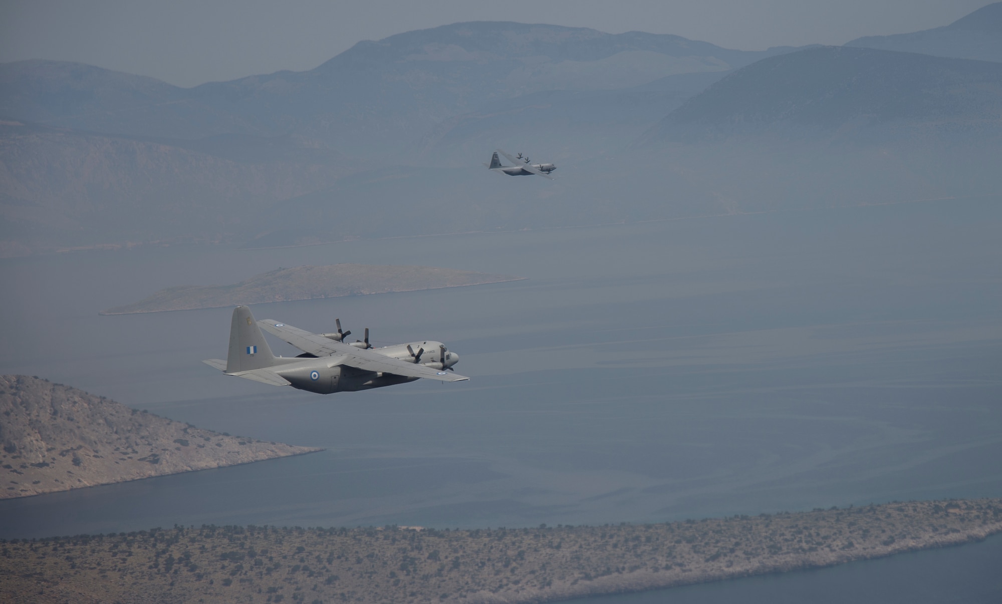 U.S. and Greek aircraft fly in formation during Stolen Cerberus III above Elefsis, Greece, April 7, 2016. The flying-training deployment provided different training scenarios, which enabled the allied services to work together and gain a better understanding of how each other operates. (U.S. Air Force photo/Staff Sgt. Nancy Kasberg)
