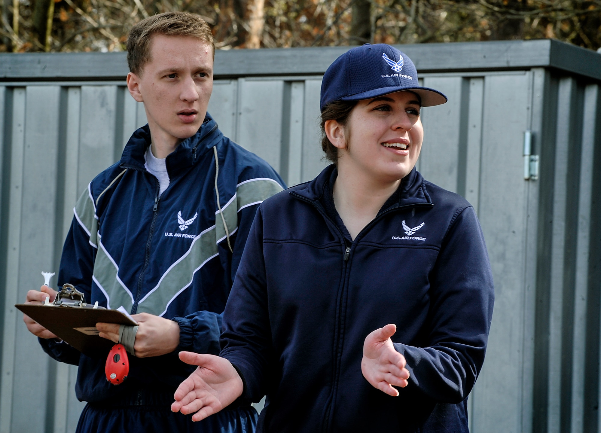 Airman 1st Class Trandon Sowell, 721st Aerial Port Squadron passenger service agent and physical training leader, keeps track of Airmen’s run times as Senior Airman Lucile Perkins-Wagel, 786th Force Support Squadron fitness assessment cell member,encourages runners during a fitness assessment April 12, 2016, at Ramstein Air Base, Germany. The FAC’s mission is to ensure each Airman is maintaining fitness standards. (U.S. Air Force photo/Senior Airman Larissa Greatwood)