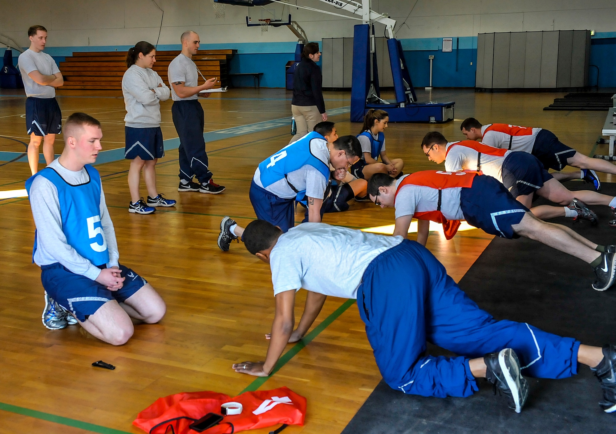 Physical training leaders watch as Airmen begin the push-up portion of a fitness assessment April 12, 2016, at Ramstein Air Base, Germany. The FAC tests roughly 145,000 Airmen annually, and relies on assistance from unit PTLs. (U.S. Air Force photo/Senior Airman Larissa Greatwood)