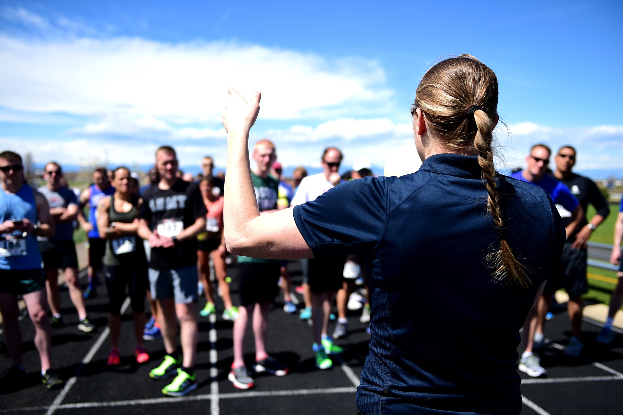 Audra Robinson, 460th Force Support Squadron fitness director, instructs the runners of the route April 14th, 2016, during the Dash to Distance 5K at the outdoor track on Buckley Air Force Base, Colo. Prizes were awarded for the top male and female finishers, along with Commander’s Cup points. (U.S. Air Force photo by Senior Airman Racheal E. Watson/Released)