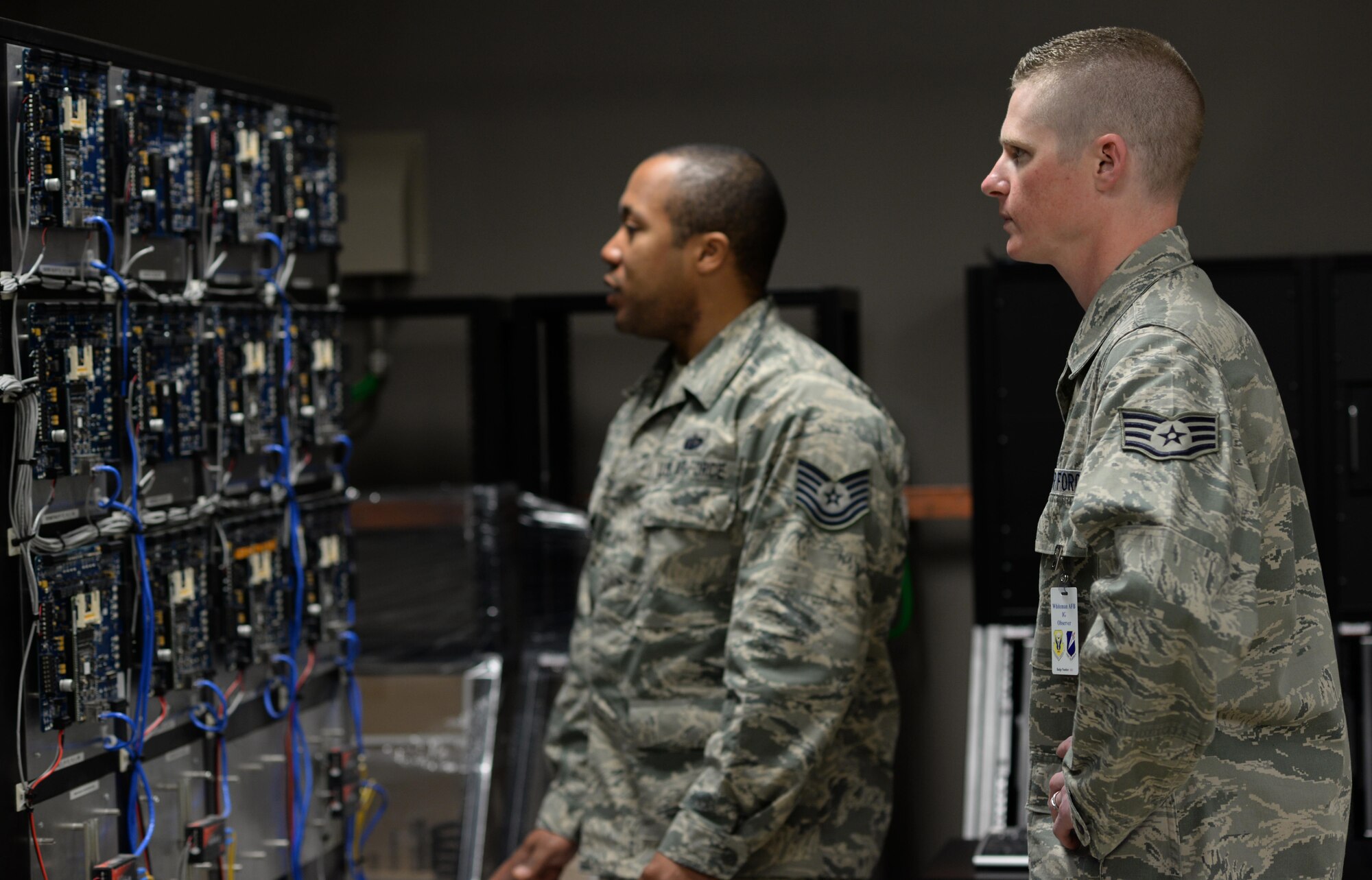 U.S. Air Force Tech. Sgt. Dexter Gore, left, the 509th Communications Squadron NCO in charge of intrusion detection systems, describes the features of Air Force Global Strike Command’s electronic security systems training lab to Staff Sgt. Robert Thomas, right, the 90th Communications Squadron NCO in charge of visual imagery and intrusion detection systems, at Whiteman Air Force Base, Mo., April 13, 2016. Eleven Airmen from the 90th Missile Wing at F.E Warren Air Force Base, Wyo., participated in a sister wing exchange at Whiteman to connect and share information and ideas. (U.S. Air Force photo by Senior Airman Emili Koonce)