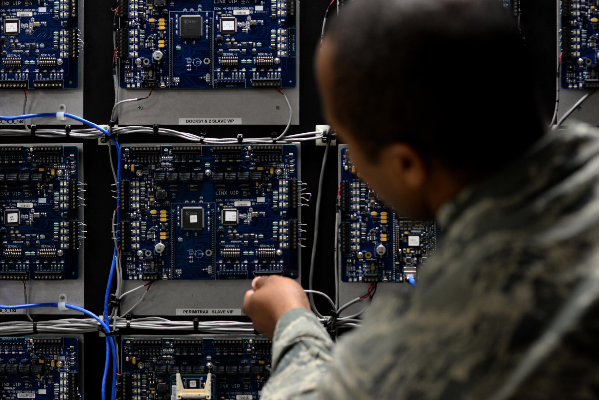 U.S. Air Force Tech. Sgt. Dexter Gore, the 509th Communications Squadron NCO in charge of intrusion detection systems, inspects perimeter sensors in the Air Force Global Strike Command’s electronic security systems training lab at Whiteman Air Force Base, Mo., April 13, 2016. Perimeter sensors are used to monitor the physical security of assets on base. (U.S. Air Force photo by Senior Airman Emili Koonce)
