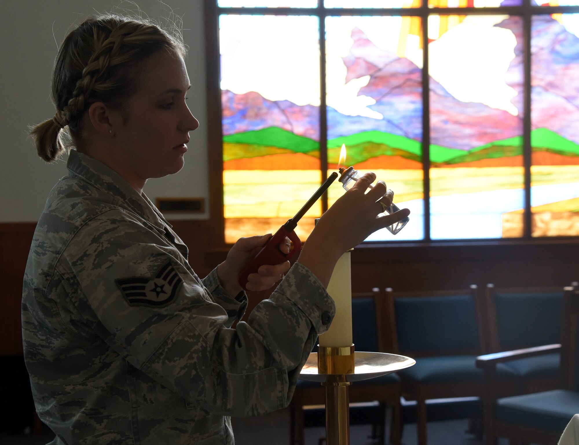 Staff Sgt. Grace Hoyt, 341st Missile Wing Chapel NCO in charge of program support, lights a candle at the base chapel April 14, 2016, at Malmstrom Air Force Base, Mont. Hoyt came into the Air Force as a space systems operator in 2009, and later cross-trained as a chaplain’s assistant. (U.S. Air Force photo/Senior Airman Jaeda Tookes)
