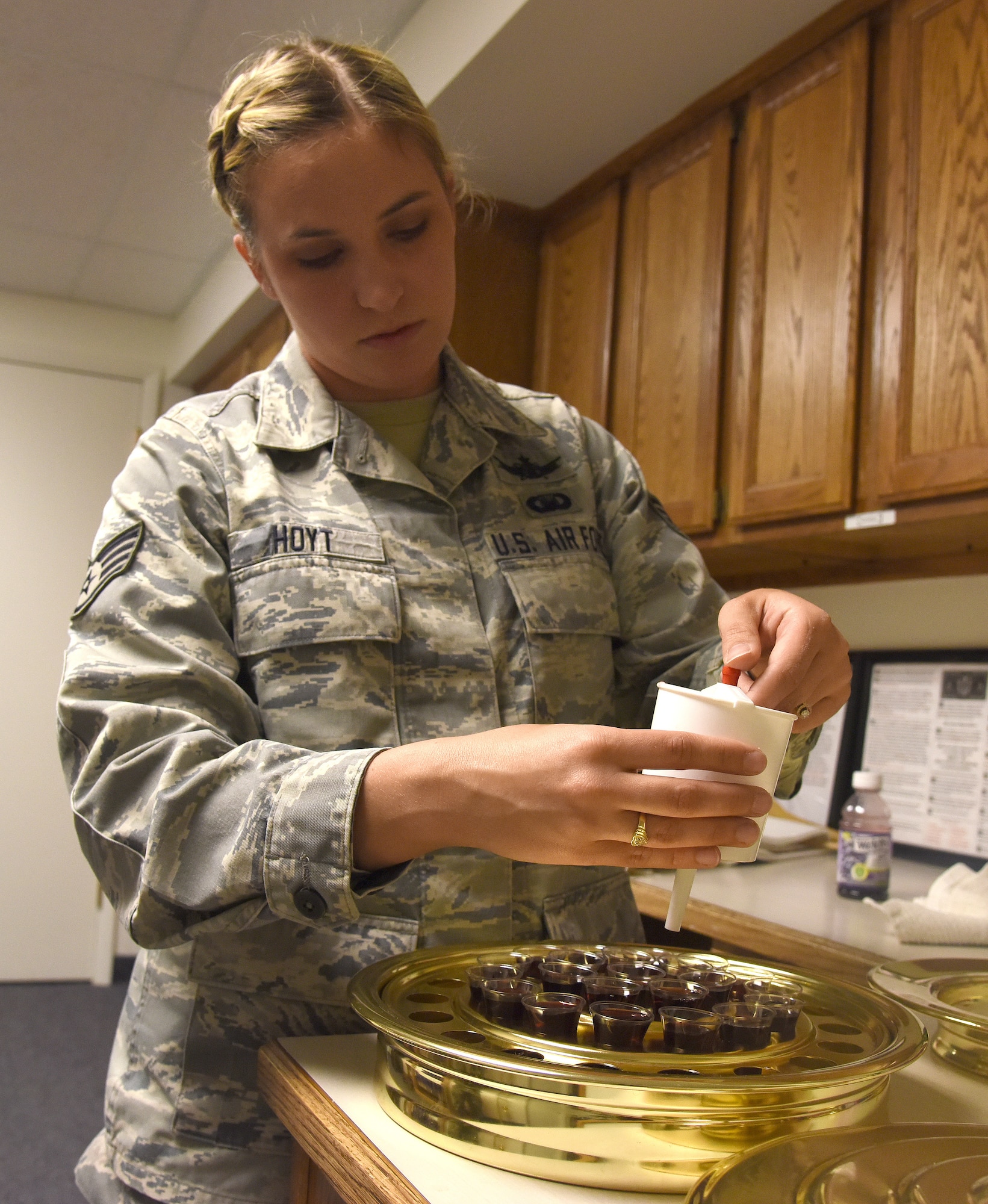 Staff Sgt. Grace Hoyt, 341st Missile Wing Chapel NCO in charge of program support, prepares sacrament for a church service at the base chapel April 14, 2016, at Malmstrom Air Force Base. Mont. Hoyt cross-trained from being a space systems operator to a chaplain’s assistant. (U.S. Air Force photo/Senior Airman Jaeda Tookes)