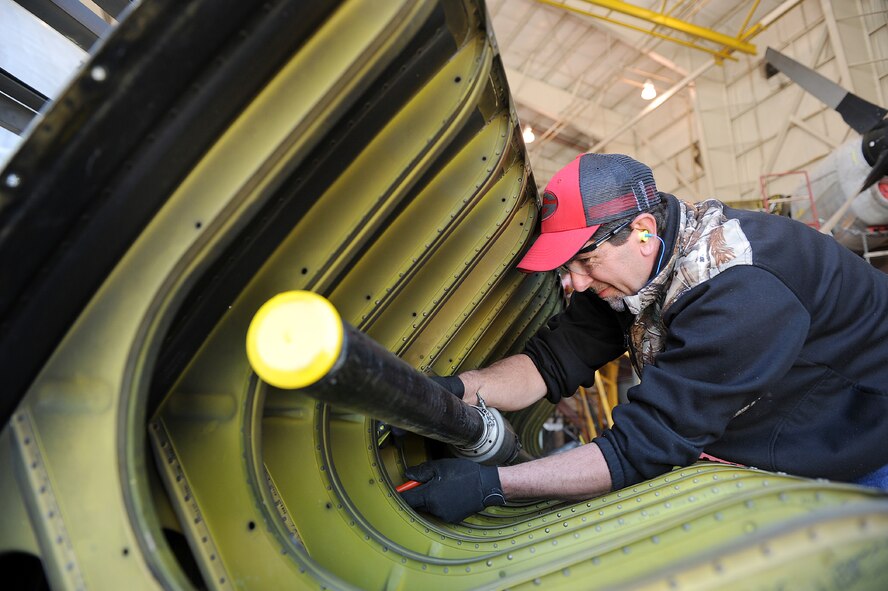 Robert Ethridge, 560th Aircraft Maintenance Squadron sheet metal mechanic, inspects the leading edge of a C-130 wing.  (U.S. Air Force photo by Tommie Horton)

