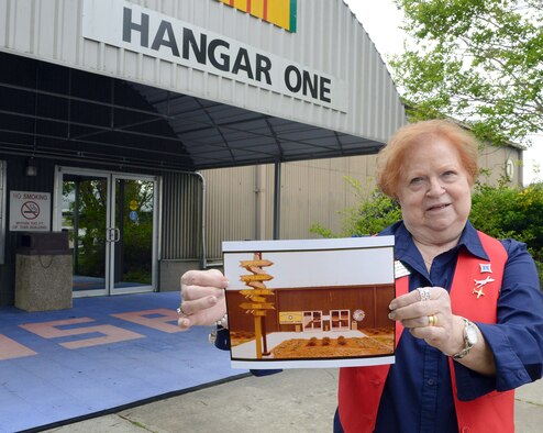 Linda Doyle, Museum of Aviation volunteer, shows a picture of Hangar One from  25 years ago. (U.S. Air Force photo by Tommie Horton)
