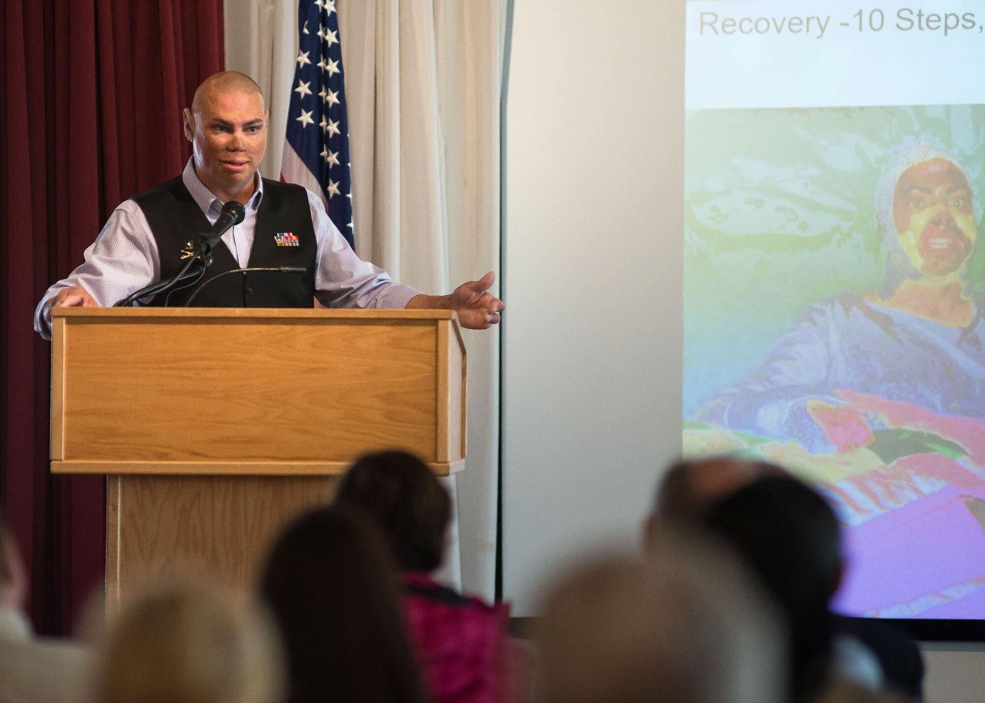 Retired U.S. Army Staff Sgt. Shilo Harris, a wounded warrior and motivational speaker, addresses members of the base community at the Minuteman Commons April 14. Harris, who was injured by an improvised explosive device while serving in Iraq, spoke about his ability to persevere and thrive in spite of the trauma and tragedy he has endured. (U.S. Air Force photo by Mark Herlihy)