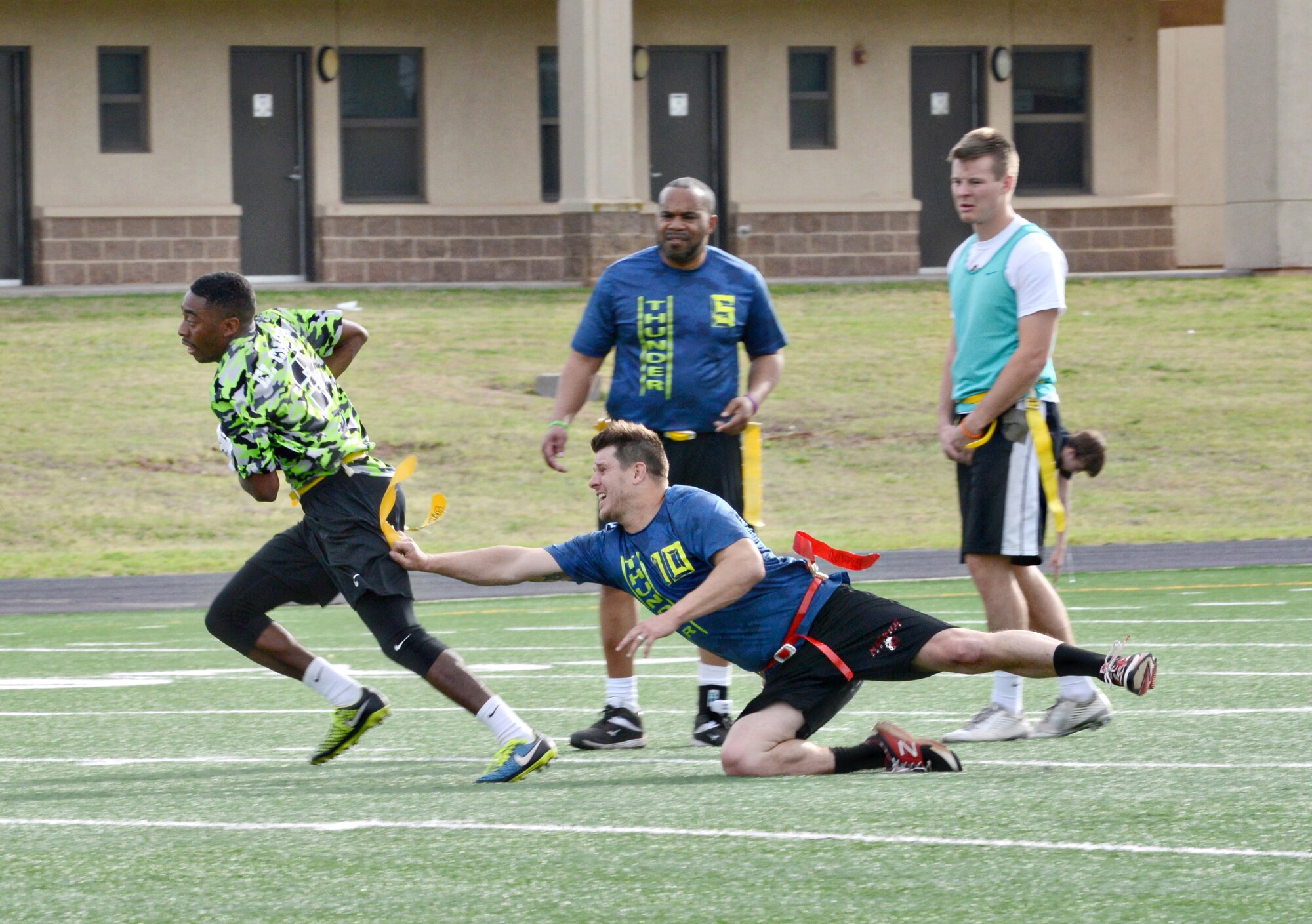 SCMS’ Matt Starzenski pulls the flag from Swamp Donkeys’ KJ Roebuck during their Tuesday night matchup. Swamp Donkeys shut out SCMS 21-0. (Air Force photo by Kelly White/Released)