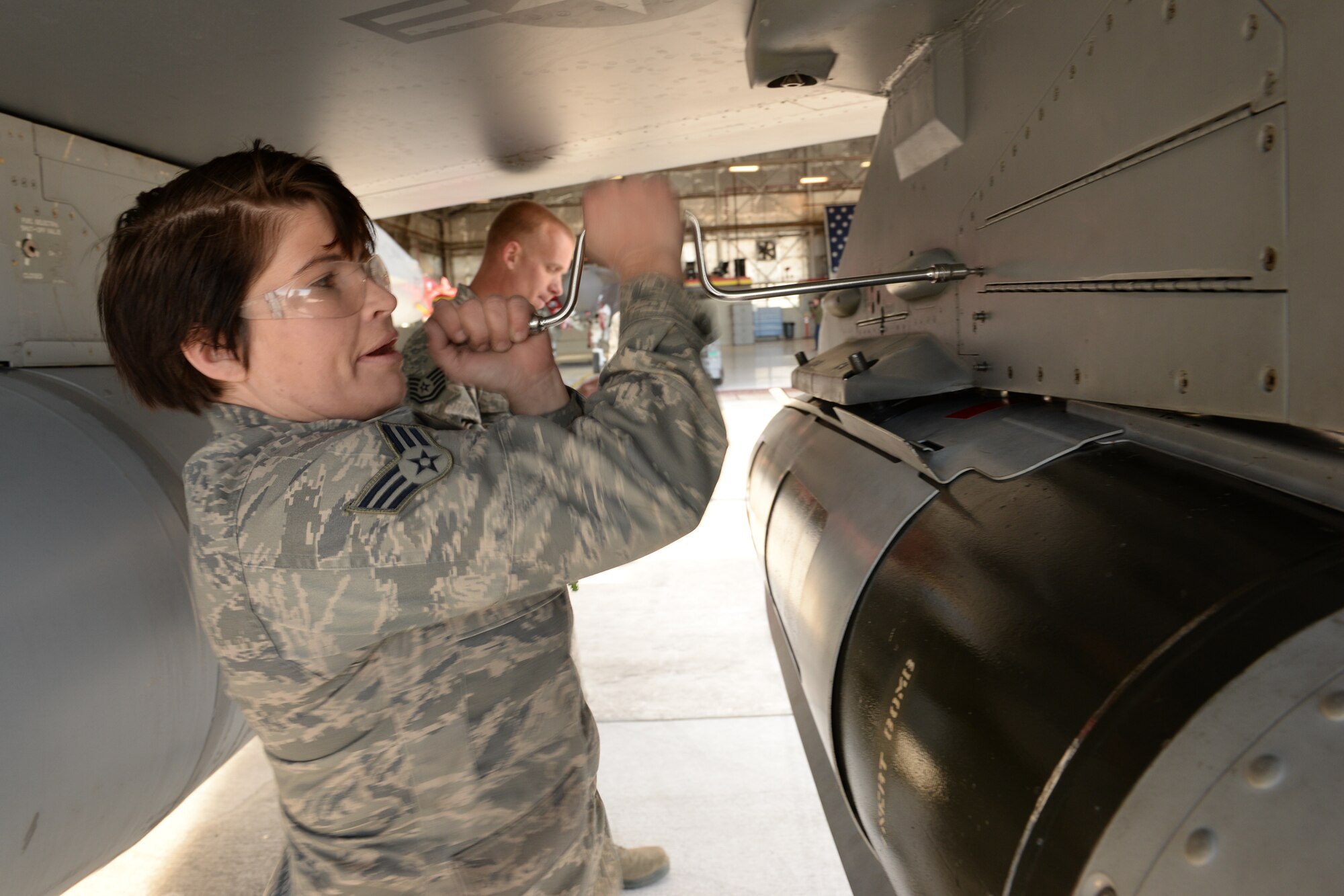 Senior Airman Trisha Himes, assigned to the 4th Aircraft Maintenance Unit, closes an MAU-12 cable access panel on an F-16 aircraft bomb rack after loading a GBU-31 bomb during the 388th Fighter Wing’s quarterly weapons load competition April 8 at Hill Air Force Base, Utah. The competition featured teams from four AMUs, including one F-35A Lightning II team, a first in a quarterly competition at Hill. (U.S. Air Force photo by Paul Holcomb)