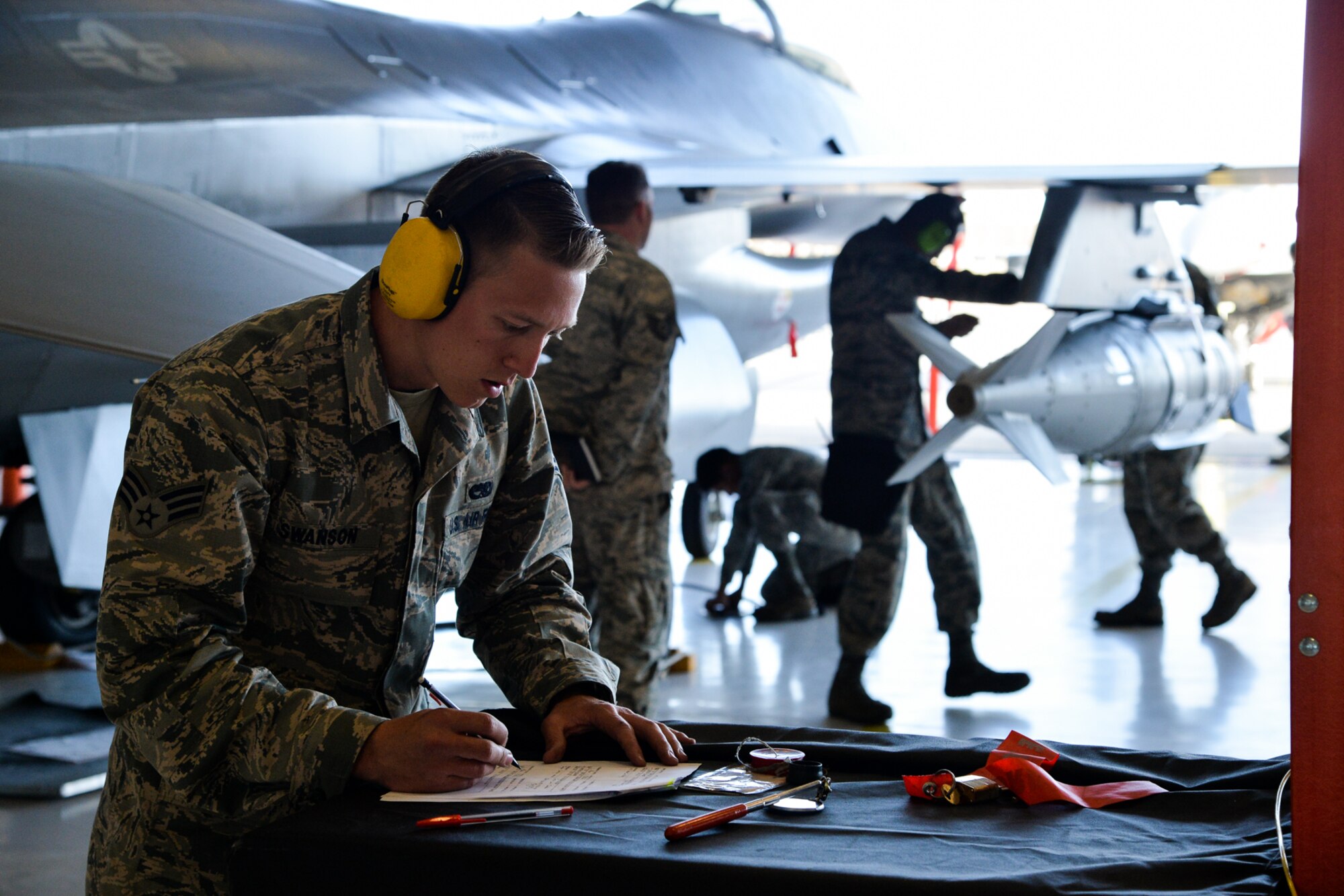 Senior Airman Hunter Swanson, 421st Aircraft Maintenance Unit, fills out aircraft forms during the 388th Fighter Wing’s quarterly weapons load competition April 8 at Hill Air Force Base, Utah. (U.S. Air Force photo by R. Nial Bradshaw)
