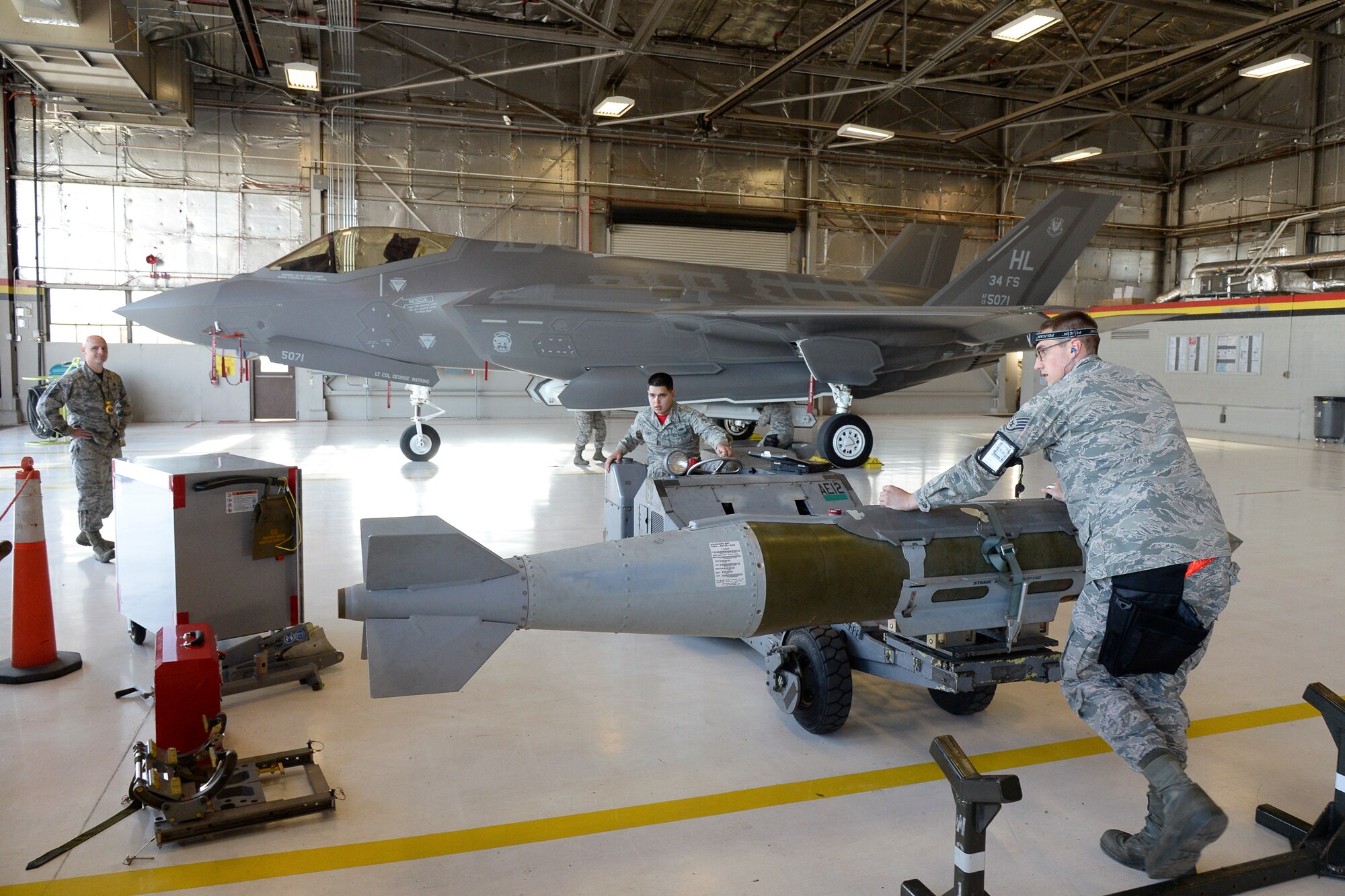 Evaluator Master Sgt. Jeffrey Taggart, 388th Maintenance Group, Airman Juan Rivas and Staff Sgt. Jeffrey Kalsbeek, both assigned to the 388th Aircraft Maintenance Squadron,  prepare ordnance during the 388th Fighter Wing quarterly weapons load competition April 8 at Hill Air Force Base, Utah. Rivas and Kalsbeek were chosen to compete as the first team to load an F-35 aircraft while competing against similar teams loading F-16 aircraft. (U.S. Air Force photo by Todd Cromar)