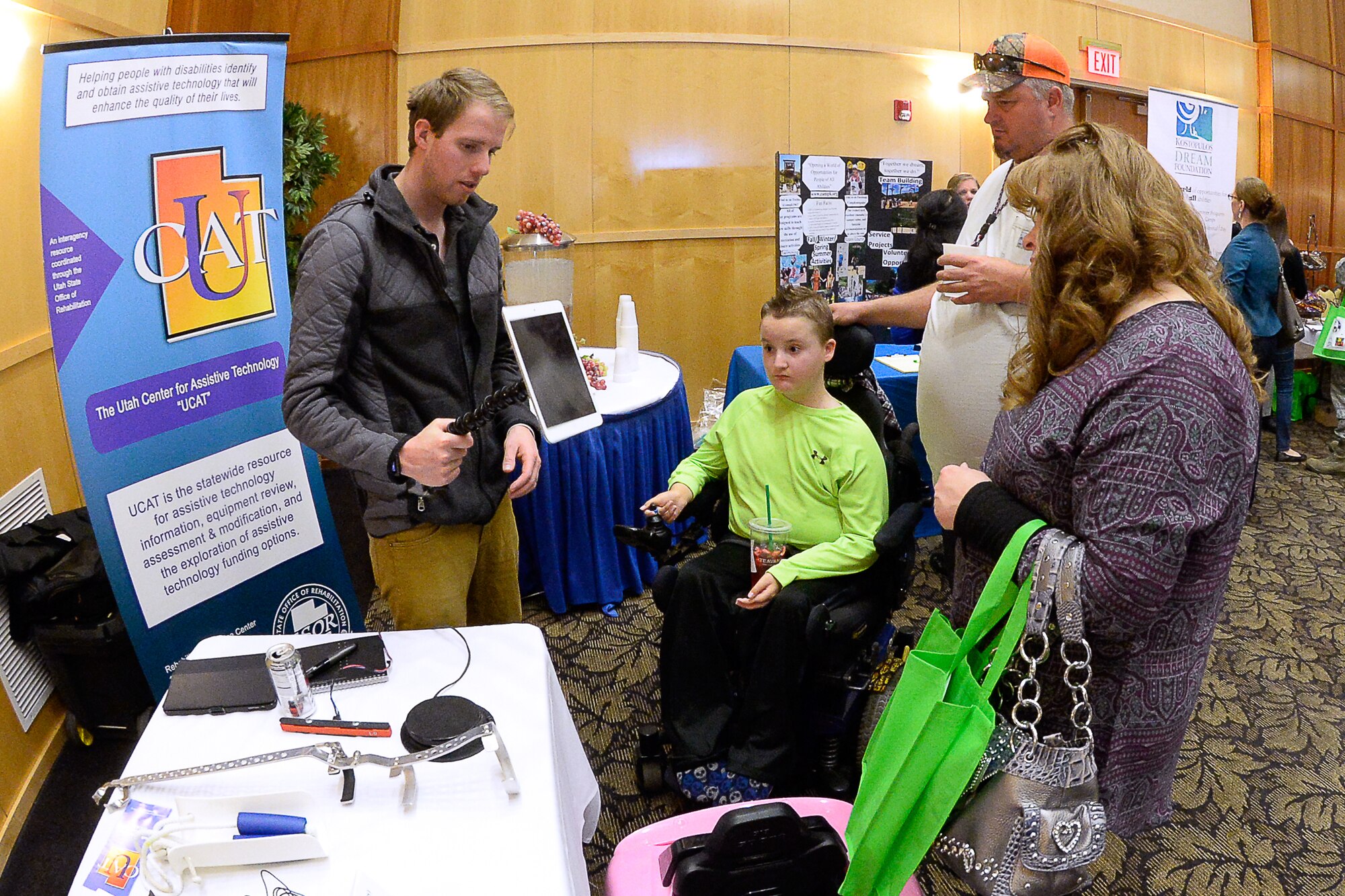 Kevin Christensen, an occupational therapist with the Utah Center for Assisted Technology, showcases available devices to Ronald Petersen, Mike Petersen and Nannetta Petersen during the Special Needs Summit April 6 at Hill Air Force Base. (U.S. Air Force photo by Todd Cromar)