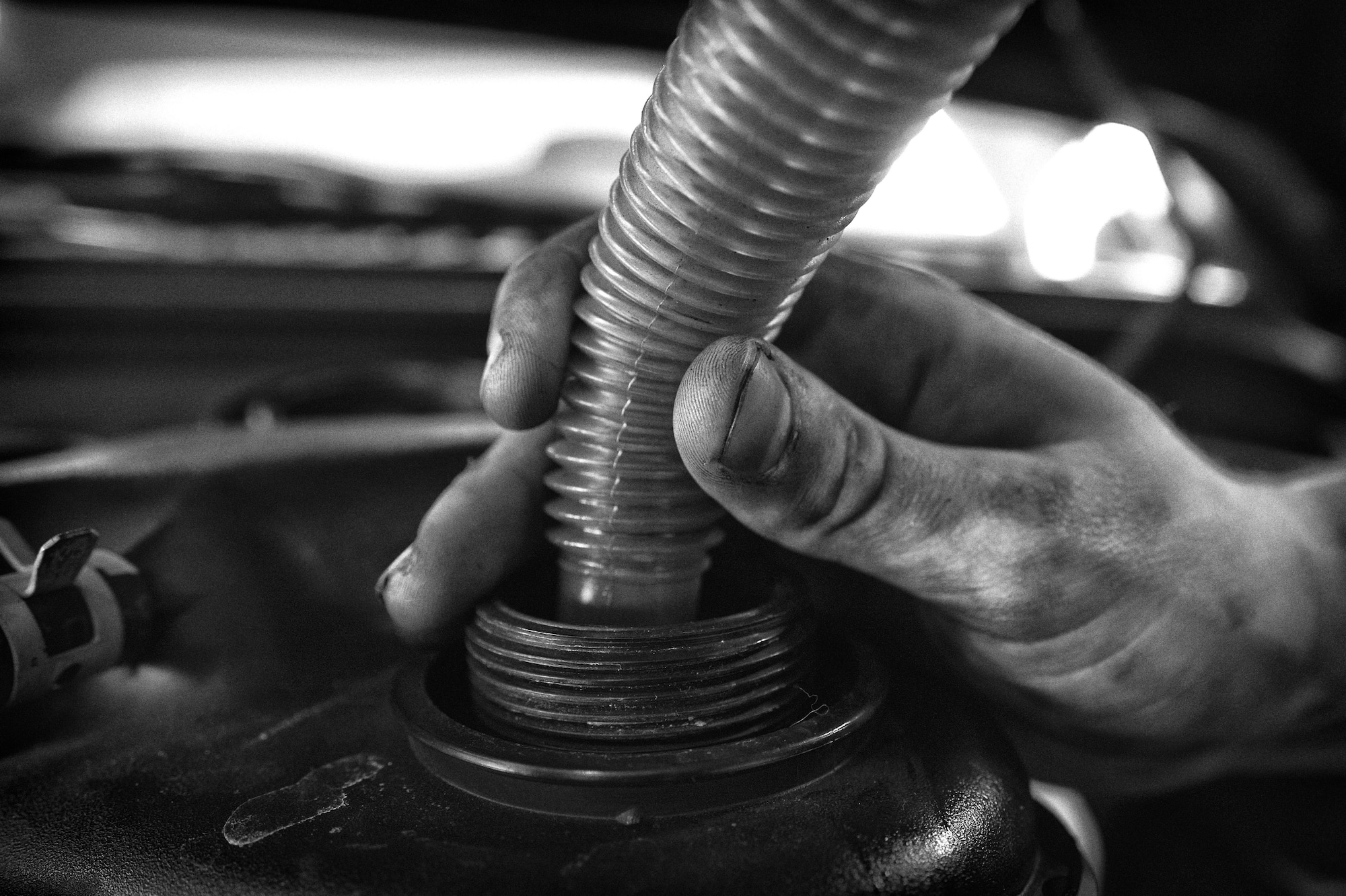 Senior Airman Michael Siters, 374th Logistics Readiness Squadron vehicle maintenance journeyman, funnels antifreeze into a government vehicle at Yokota Air Base, Japan, April 13, 2016. The shop ensures the upkeep of all Yokota’s government vehicles by providing regular maintenance and repair. (U.S. Air Force photo by Senior Airman Delano Scott/Released)