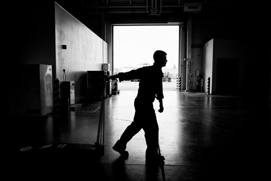 Airman 1st Class Justin Stephens, 374th Logistics Readiness Squadron vehicle maintenance apprentice, pulls a dolly across the vehicle maintenance shop at Yokota Air Base, Japan, April 13, 2016. The vehicle maintenance shop services more than 1,100 vehicles valued at $118 million. (U.S. Air Force photo by Senior Airman Delano Scott/Released)