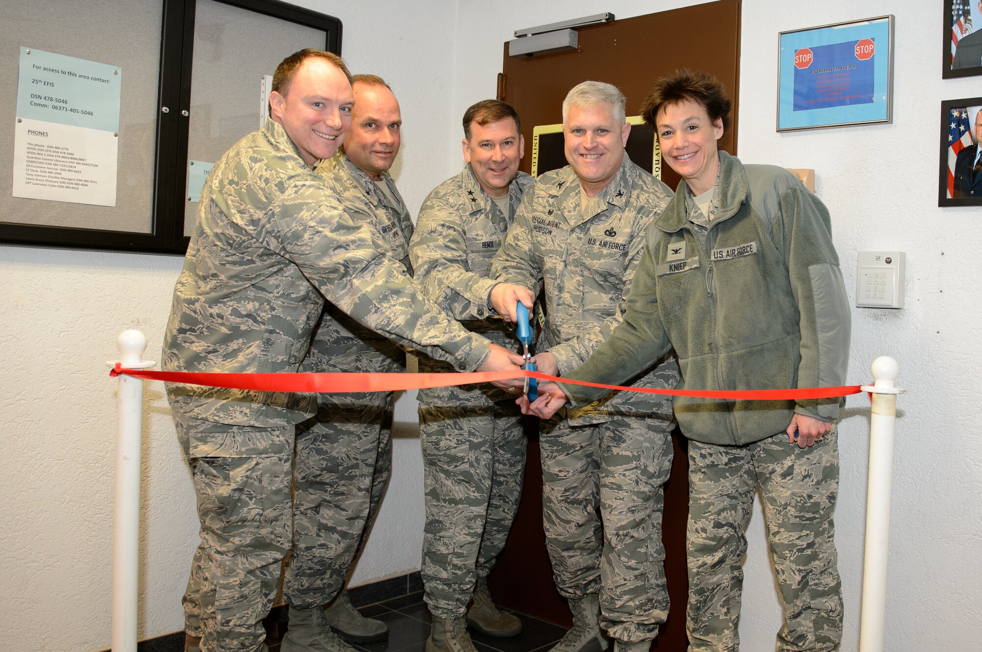 Left to right: Maj. Drew Schofield, Brig. Gen. Keith M. Givens, Maj. Gen. Christopher Bence, Col. James Hudson and Col. Andrea Kneip cut the symbolic ribbon March 14, 2016, to officially open the new 25th Expeditionary Field Investigations Squadron office space at Ramstein Air Base, Germany. (Photo courtesy 25 EFIS.)
