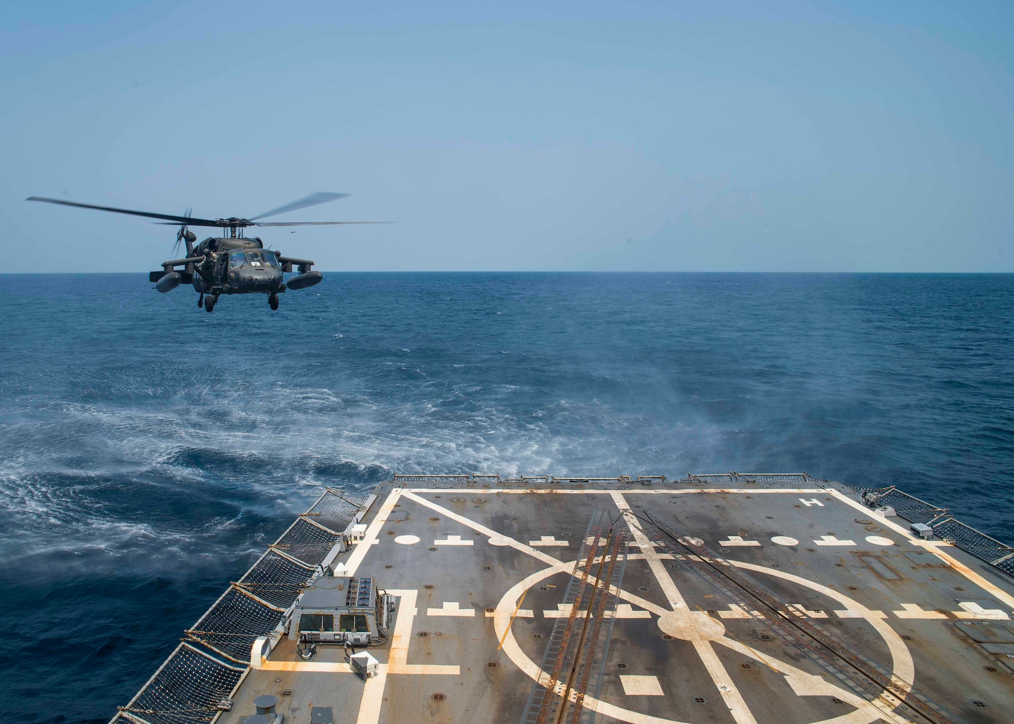 A UH-60 Blackhawk assigned to the 1st Battalion, 228th Aviation Regiment, Joint Task Force Bravo at Soto Cano Air Base, Honduras, prepares to land aboard the USS Lassen during deck landing qualifications off the coast of Honduras, April 14, 2016. The 1-228 enables partner-nation counter-trafficking missions and humanitarian assistance/disaster relief efforts throughout Central America. (U.S. Air Force photo by Staff Sgt. Siuta B. Ika)