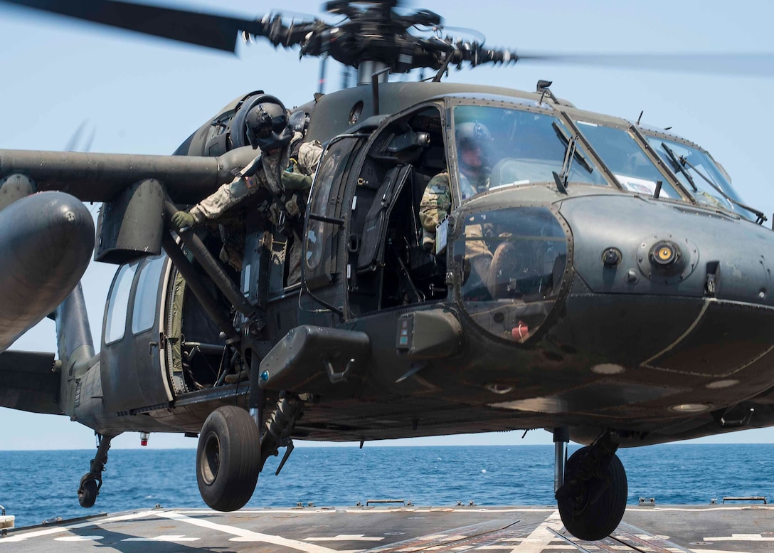 A UH-60 Blackhawk assigned to the 1st Battalion, 228th Aviation Regiment, Joint Task Force Bravo at Soto Cano Air Base, Honduras, launches from the helipad of the USS Lassen during deck landing qualifications off the coast of Honduras, April 14, 2016. The deck landing qualifications familiarizes Blackhawk crews with shipboard operations and enhances their ability to conduct a variety of operations in the U.S. Southern Command’s area of responsibility. (U.S. Air Force photo by Staff Sgt. Siuta B. Ika)