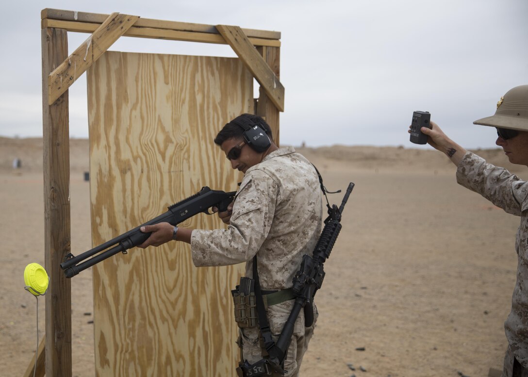 Cpl. Anthony Lubbers, designated marksmanship instructor, Combat Center Marksmanship Training Unit, prepares to breach a door at the Western Regional Combat Match April 8, 2016. (Official Marine Corps photo by Cpl. Connor Hancock/Released)