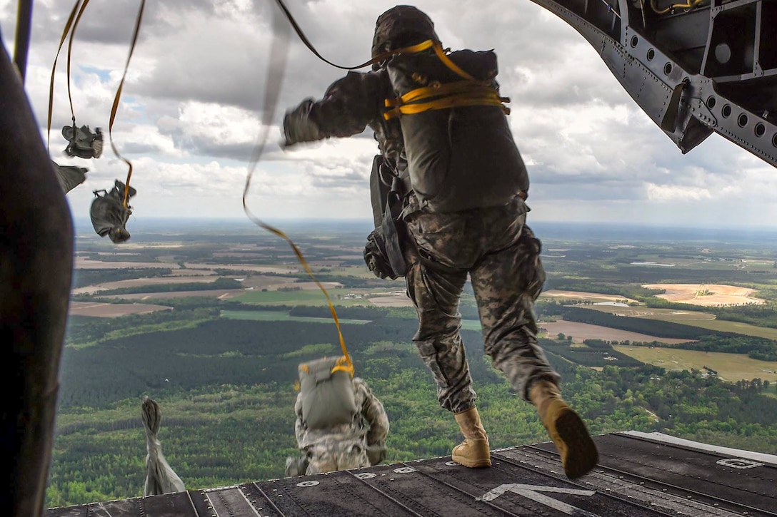 Soldiers jump from a CH-47 Chinook helicopter during Operation Skyfall USA in Sylvania, Ga., April 11, 2016. The soldiers are assigned to the 982nd Combat Camera Company (Airborne) and the 55th Signal Company. Air Force photo by Senior Airman Keith James
