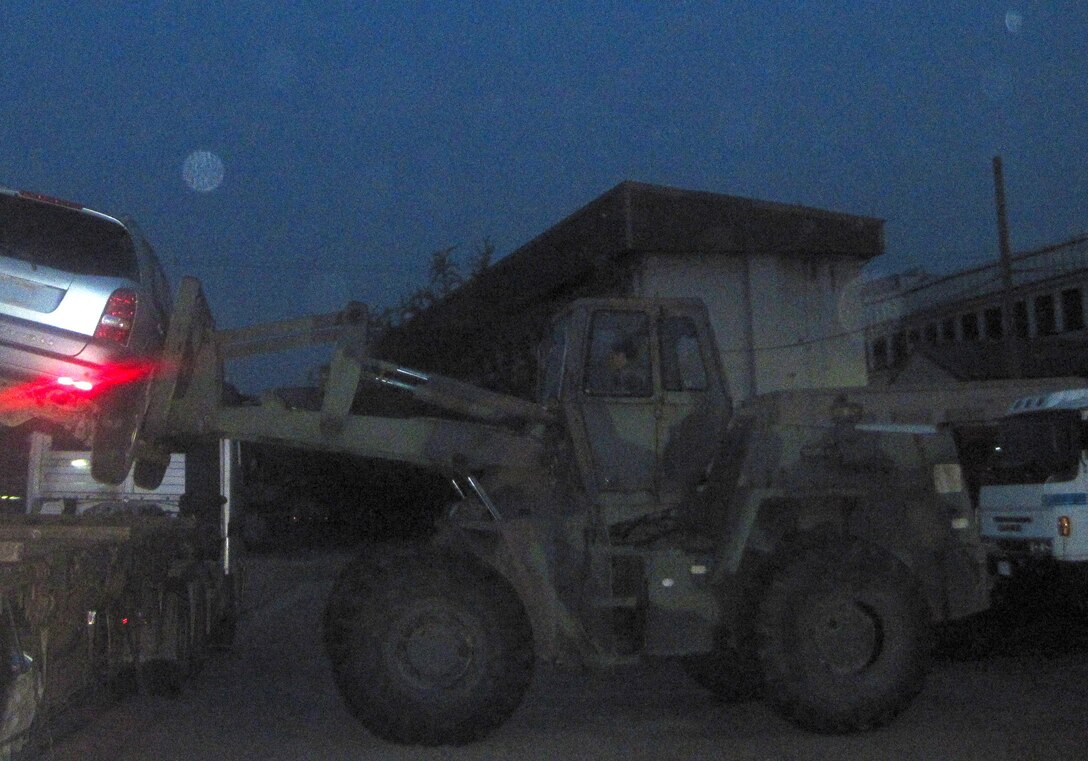 Morning came early at the Far East District motor pool, as tractor-trailers arrived just after 5 a.m. to haul obsolete vehicles to the Defense Reutilization Management Office (DRMO). The obsolete vehicles were loaded by forklift, tied down and departed the compound in about an hour.