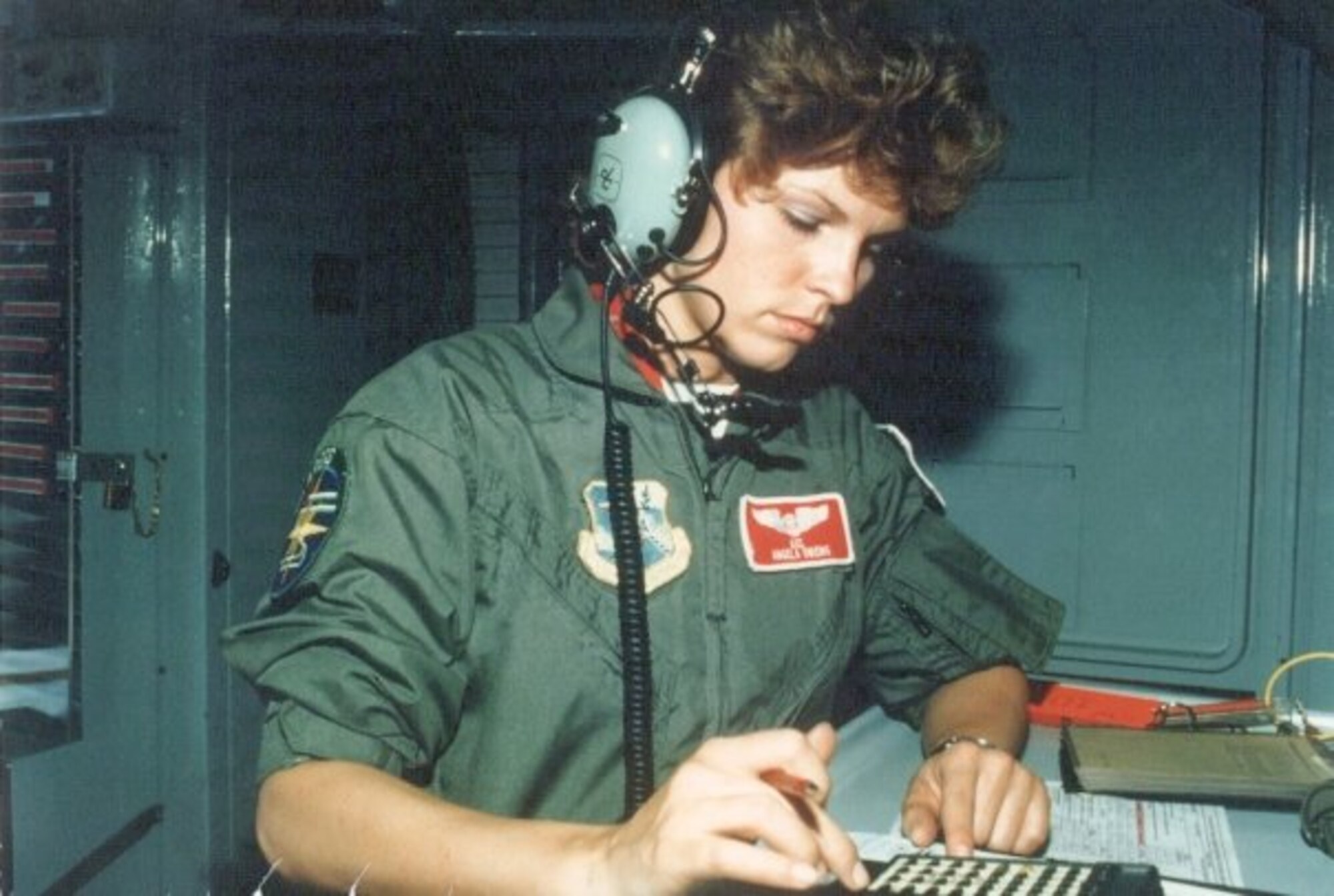 Senior Airman Angela Owens inputs data onto a hand held weight and balance calculator to determine the aircraft’s center of gravity in December of 1989. Owens served four years as a KC-10 Extender boom operator before she re-trained into the air traffic control career field. (Courtesy Photo)