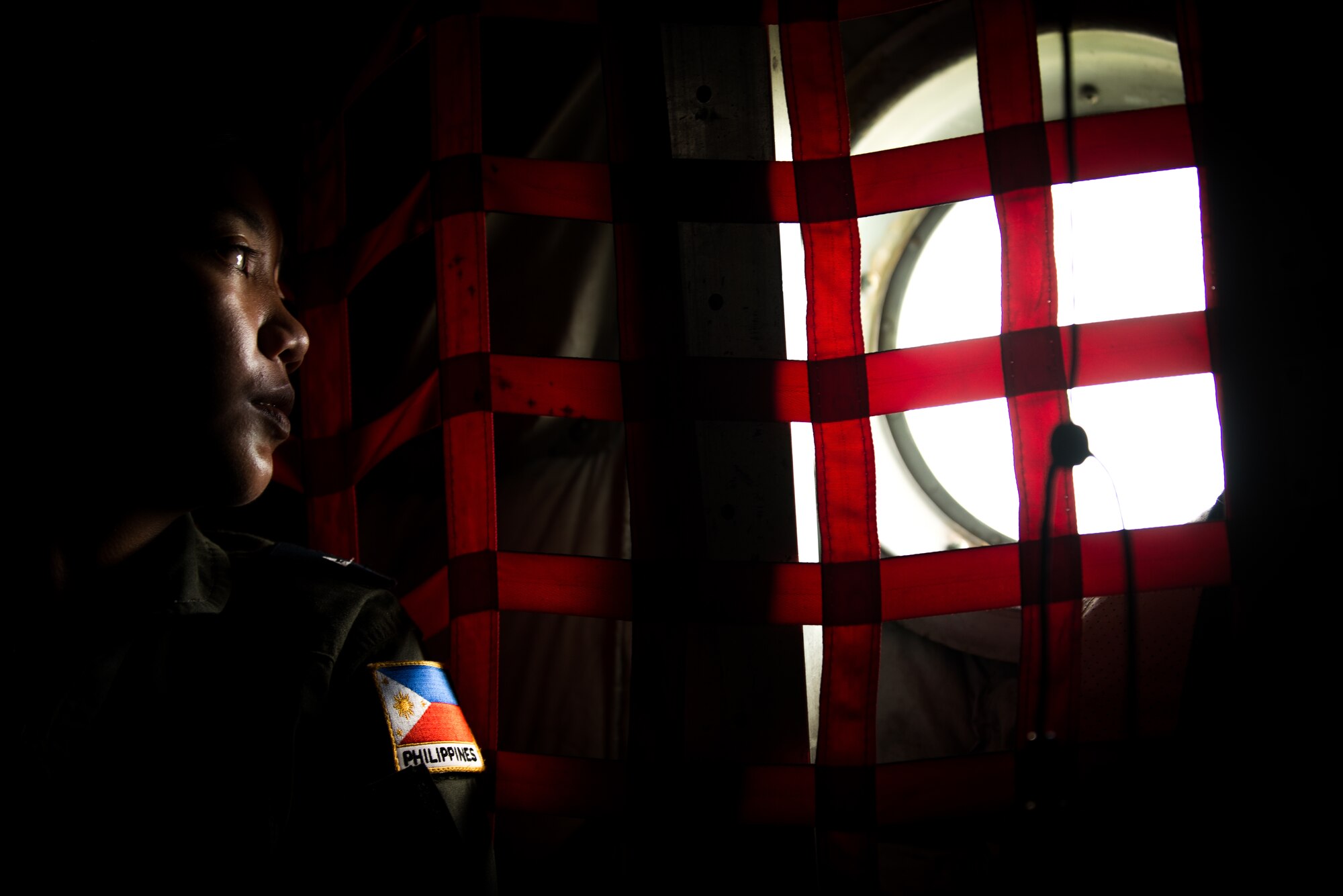 Philippine Air Force 2nd Lt. Aniza Noreem A. Monje, 220th Airlift Wing pilot, looks out of a 36th Airlift Squadron C-130 Hercules window during an Exercise Balikatan flight off the coast of Mactan, Philippines, April 14, 2016. Balikatan provides opportunities for U.S. and Philippine forces to learn from each other and train for potential real world crises, better preparing them to support the local population throughout the Indo-Asia-Pacific region.(U.S. Air Force photo by Staff Sgt. Michael Smith/ Released)
