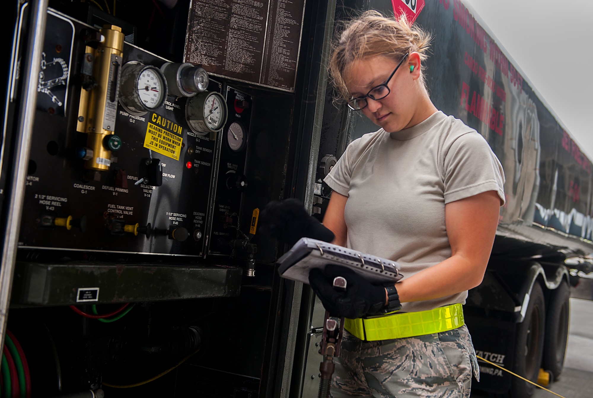 U.S. Air Force Airman 1st Class Anyssa Yanez, 18th Logistics Readiness Squadron fuels distribution operator, reviews her checklist while refueling an F-15 Eagle April 13, 2016, at Kadena Air Base, Japan. Petroleum, oil and lubricant Airmen drive the massive R-11 refueling truck to an awaiting aircraft to provide them with the fuel they need to continue the mission. (U.S. Air Force photo by Airman 1st Class Corey M. Pettis)