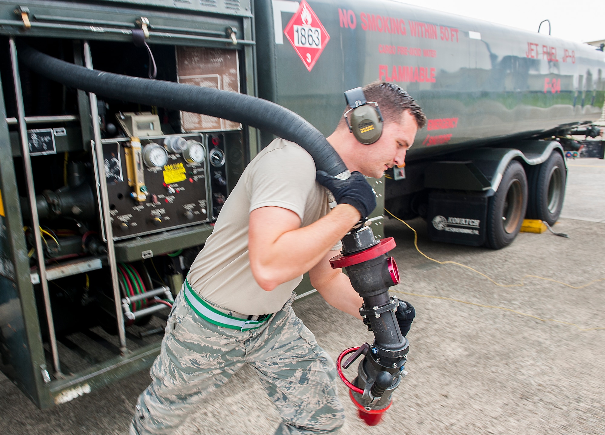 U.S. Air Force Airman 1st Class Terry Gilman, 18th Logistics Readiness Squadron fuels distribution operator, pulls out a hose to refuel an aircraft April 13, 2016, at Kadena Air Base, Japan. Petroleum, oil and lubricant Airmen fuel the fight and are vital in keeping aircraft ready to go. (U.S. Air Force photo by Airman 1st Class Corey M. Pettis)