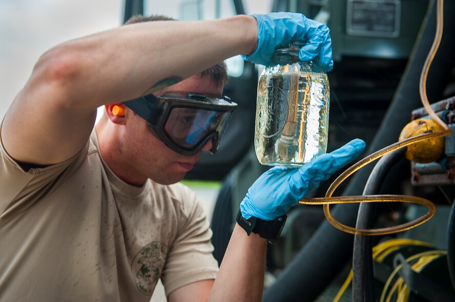 U.S. Air Force Staff Sgt. Nicholas Samuelson, 18th Logistics Readiness Squadron fuels distribution supervisor, samples fuel from a pump house April 13, 2016, at Kadena Air Base, Japan. The fuel is pumped out of the ground by an R-12 refueling truck and tested for impurities before going into an aircraft. (U.S. Air Force photo by Airman 1st Class Corey M. Pettis/Released)