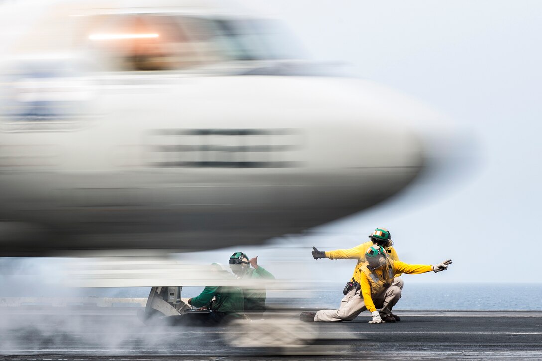 Sailors signal as an E-2C Hawkeye launches from the flight deck of aircraft carrier USS Harry S. Truman in the Arabian Gulf, April 13, 2016. The Harry S. Truman Carrier Strike Group is supporting Operation Inherent Resolve and other security efforts in the U.S. 5th Fleet area of responsibility. Navy photo by Petty Officer 2nd Class Ethan T. Miller