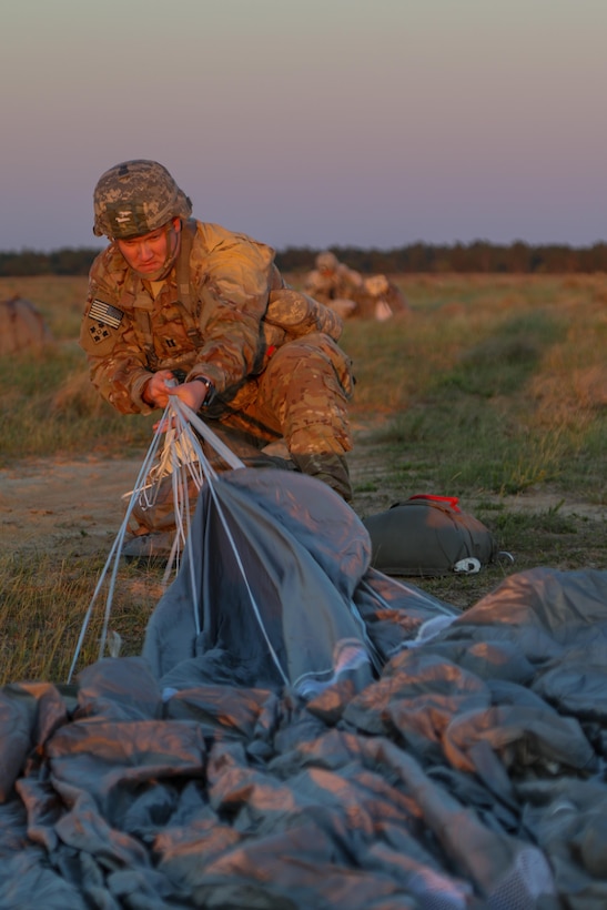 Army Capt. Justin W. Golden recovers his parachute during a Mungadai training mission at Fort Bragg, N.C., April 5, 2016. A "Mungadai" is name derived from a test once used hundreds of years ago by Genghis Khan for his Mongolian empire's army. Golden is commander, 82nd Airborne Division's Headquarters Company, 2nd Brigade Combat Team. Army photo by Staff Sgt. Jason Hull