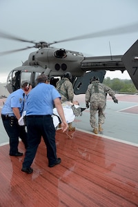 Staff Sgt. Frank Skyles and Sgt. Cody Westmoreland, UH-72A crew members from Detachment 1, Delta Company, 2nd Battalion, 151st Aviation Regiment, Louisiana Army National Guard, along with East Jefferson General Hospital emergency medical staff, transport a simulated casualty for aeromedical evacuation during a Vigilant Guard emergency exercise, April 15, 2016. 