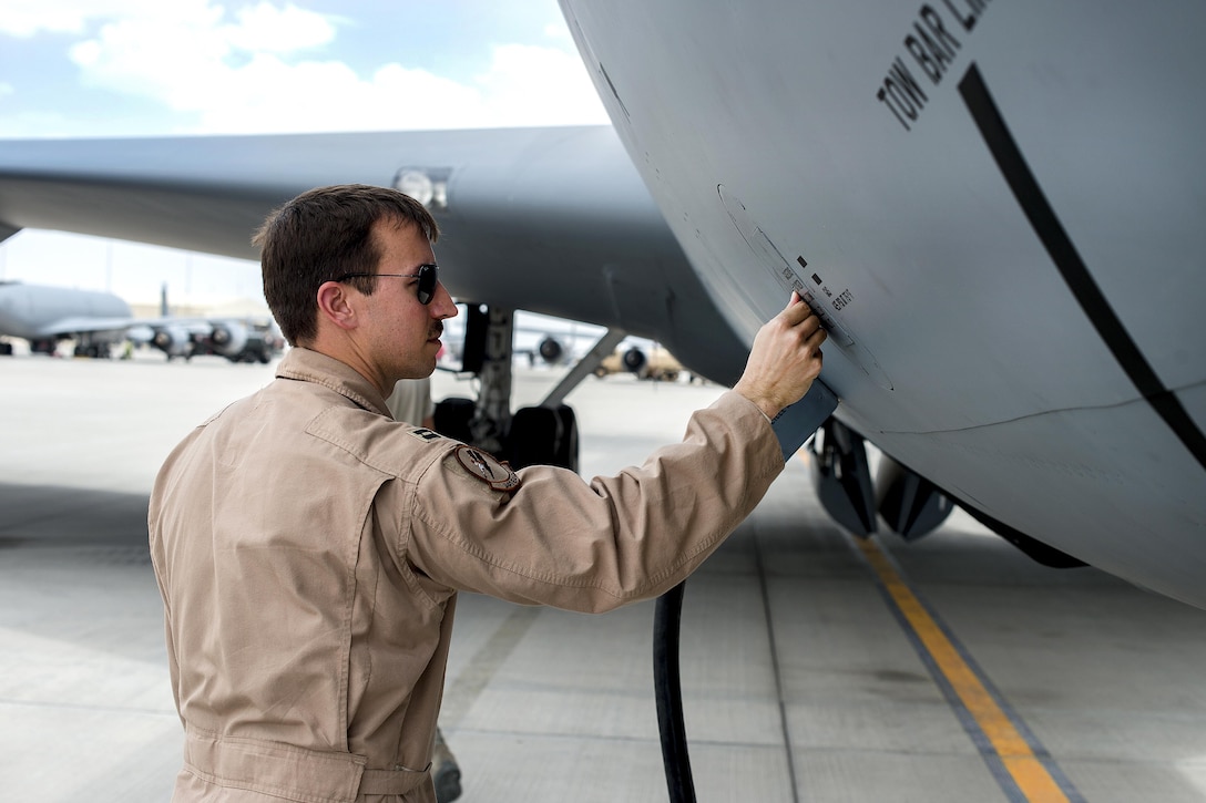 Air Force Capt. Seth performs a preflight inspection on a KC-135 Stratotanker aircraft at Al Udeid Air Base, Qatar, April 6, 2016, in support of Operation Inherent Resolve. Seth is a pilot assigned to the 340th Expeditionary Air Refueling Squadron. Air Force photo by Tech. Sgt. Nathan Lipscomb