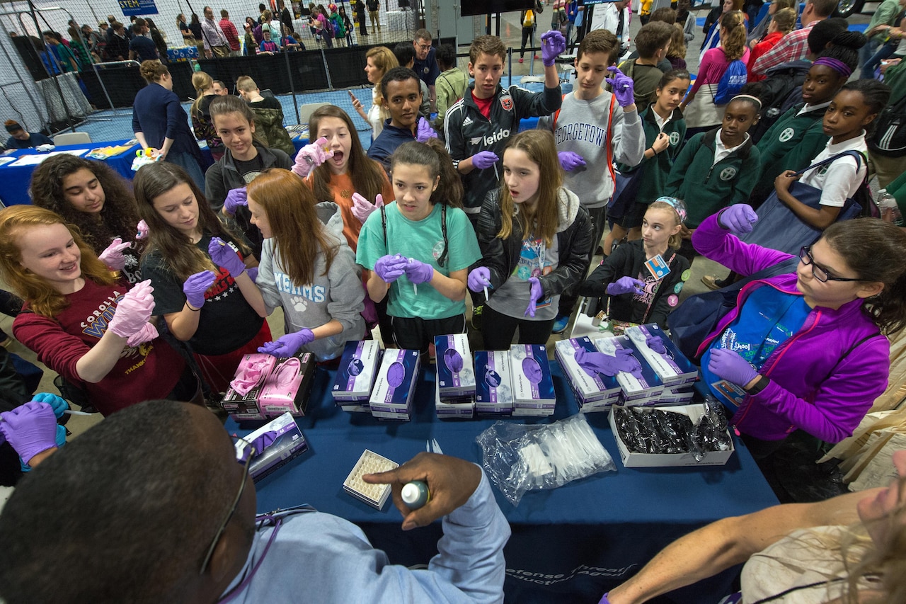 Students conduct a science experiment at a Defense Department exhibit at the USA Science and Engineering Festival in Washington, D.C., April 15, 2016. DoD photo by EJ Hersom