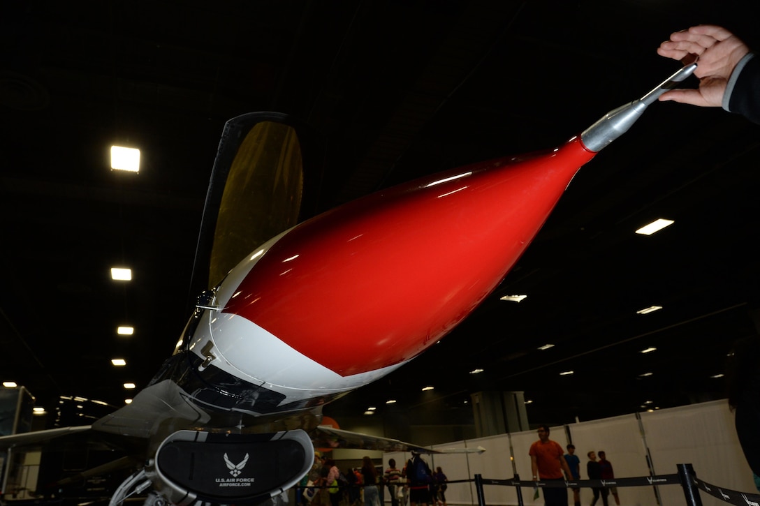 A child reaches out to touch the nose of an Air Force Thunderbird F-16 jet on display at the USA Science and Engineering Festival in Washington, D.C., April 15, 2016. DoD photo by EJ Hersom