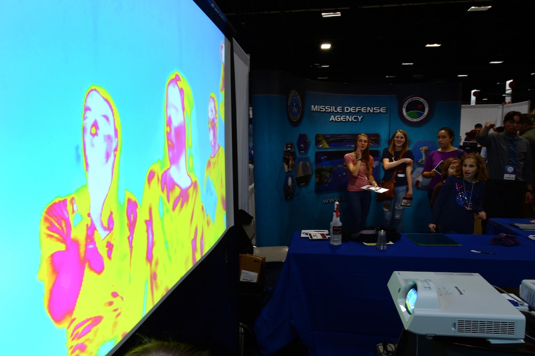 Students watch a thermal imaging video of themselves at a Defense Department display at the USA Science and Engineering Festival in Washington, D.C., April 15, 2016. DoD photo by EJ Hersom