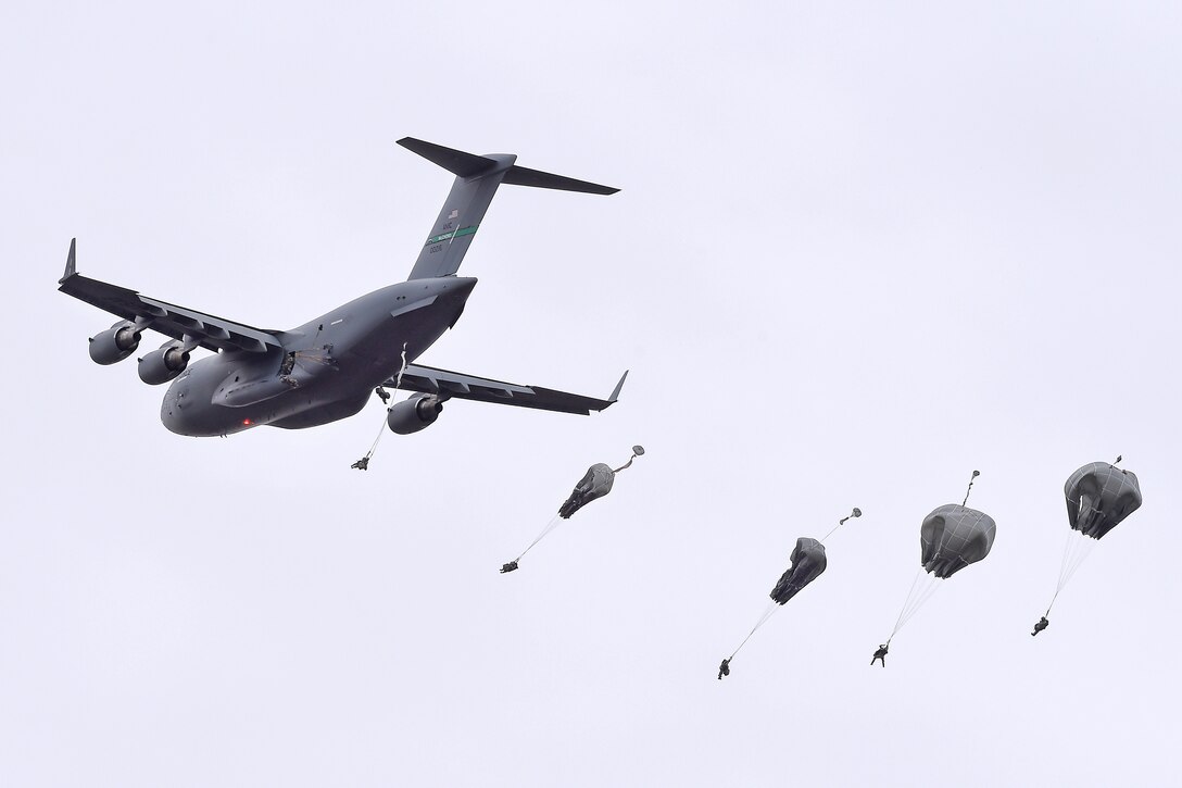 Paratroopers jump from an Air Force C-17 Globemaster III during a practice forced-entry parachute assault on Malemute drop zone at Joint Base Elmendorf-Richardson, Alaska, April 5, 2016. Air Force photo by Alex Pena