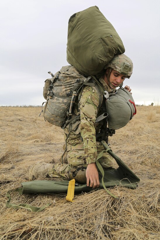 Army Sgt. Brian Meier recovers a parachute and gear during a practice forced-entry parachute assault on Malemute drop zone at Joint Base Elmendorf-Richardson, Alaska, April 5, 2016. Meier is assigned to the 25th Infantry Division’s 2nd Battalion, 377th Parachute Field Artillery Regiment, 4th Infantry Brigade Combat Team (Airborne), Alaska. Air Force photo by Alex Pena