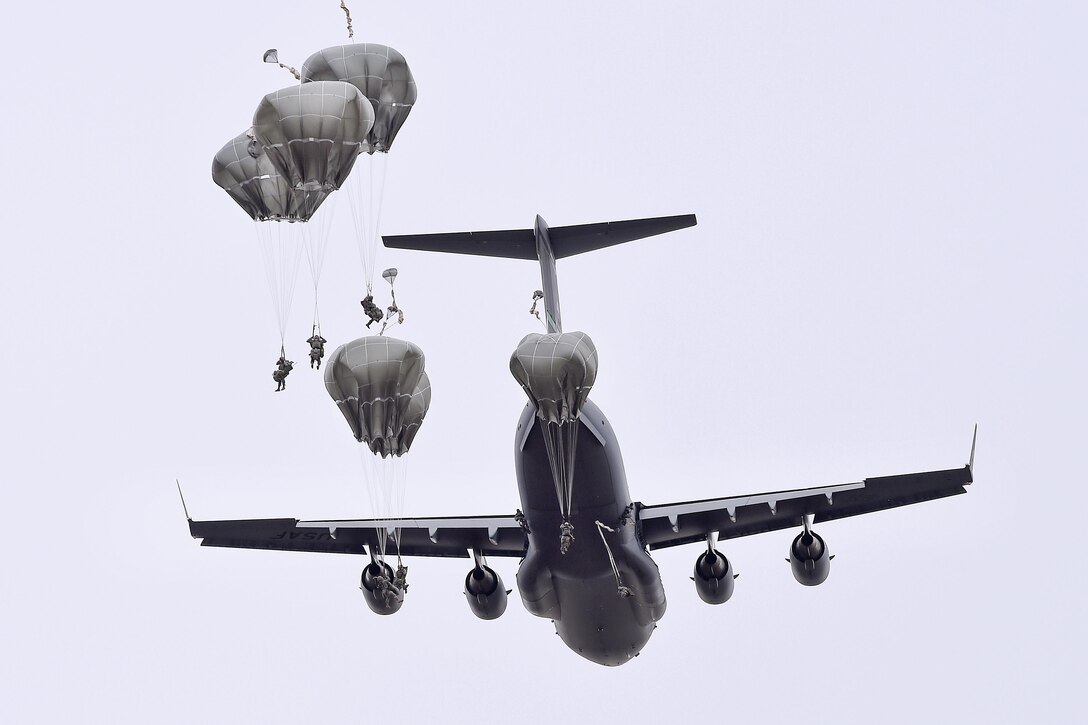 Paratroopers jump from a U.S. Air Force C-17 Globemaster III during a practice forced-entry parachute assault on Malemute drop zone at Joint Base Elmendorf-Richardson, Alaska, April 5, 2016. Air Force photo by Alex Pena